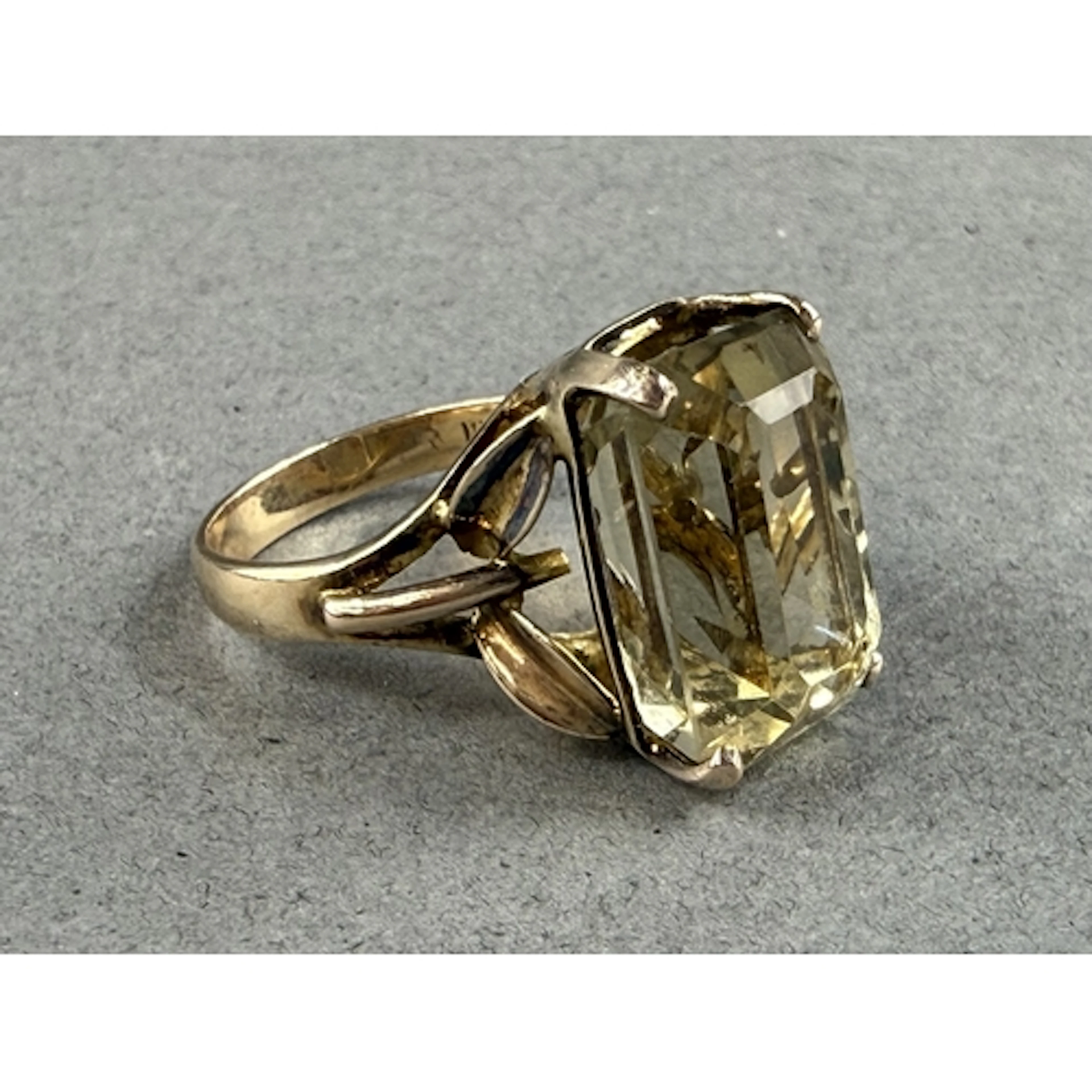 Jewellery: a yellow metal ring set a single step cut citrine...