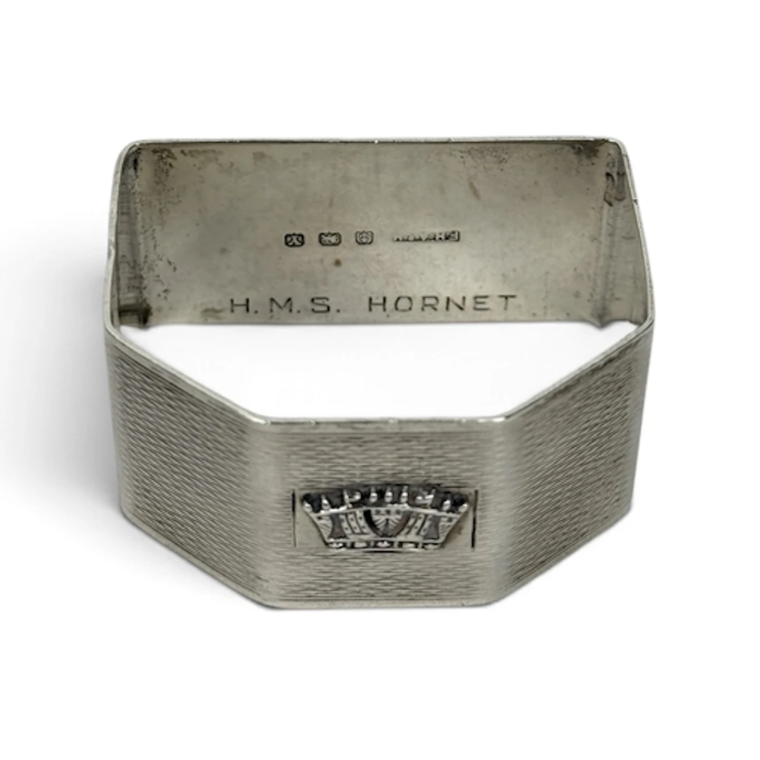 AN ENGINE TURNED SILVER NAPKIN RING, BIRMINGHAM 1948, INSCRI...