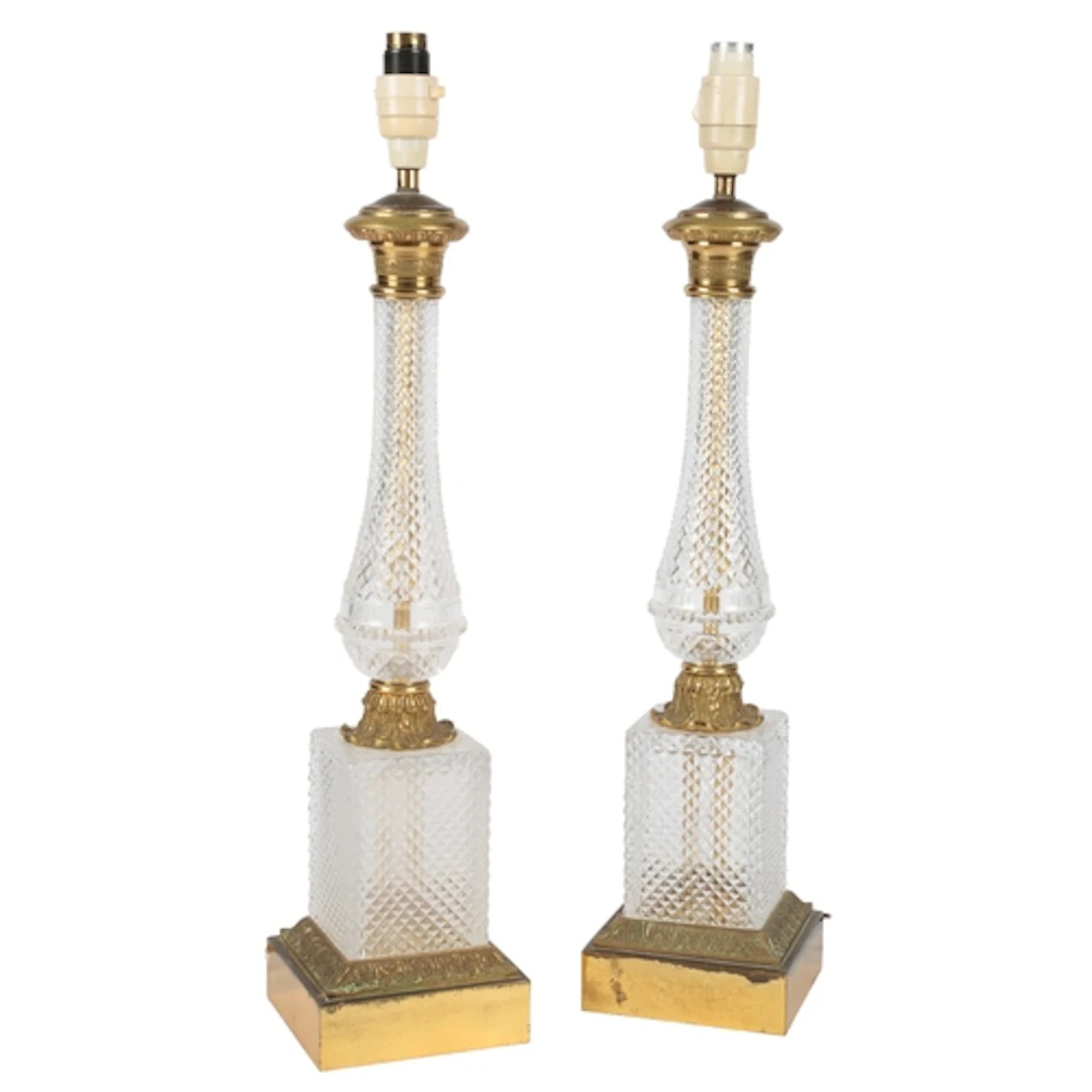 A pair of Baccarat cut glass and gilt metal table lamps, lat...