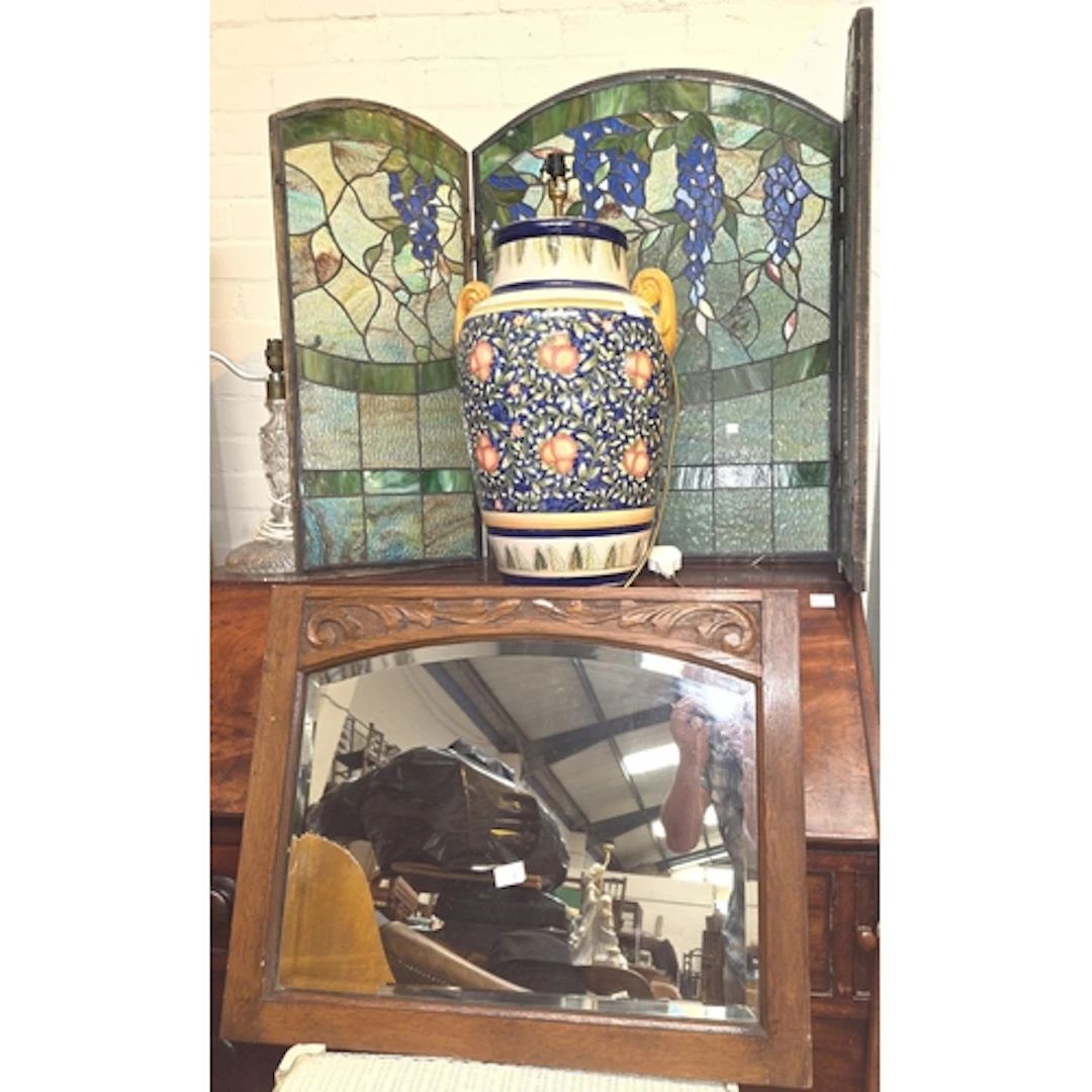 A coloured stained glass fire screen, a large ceramic lamp a...