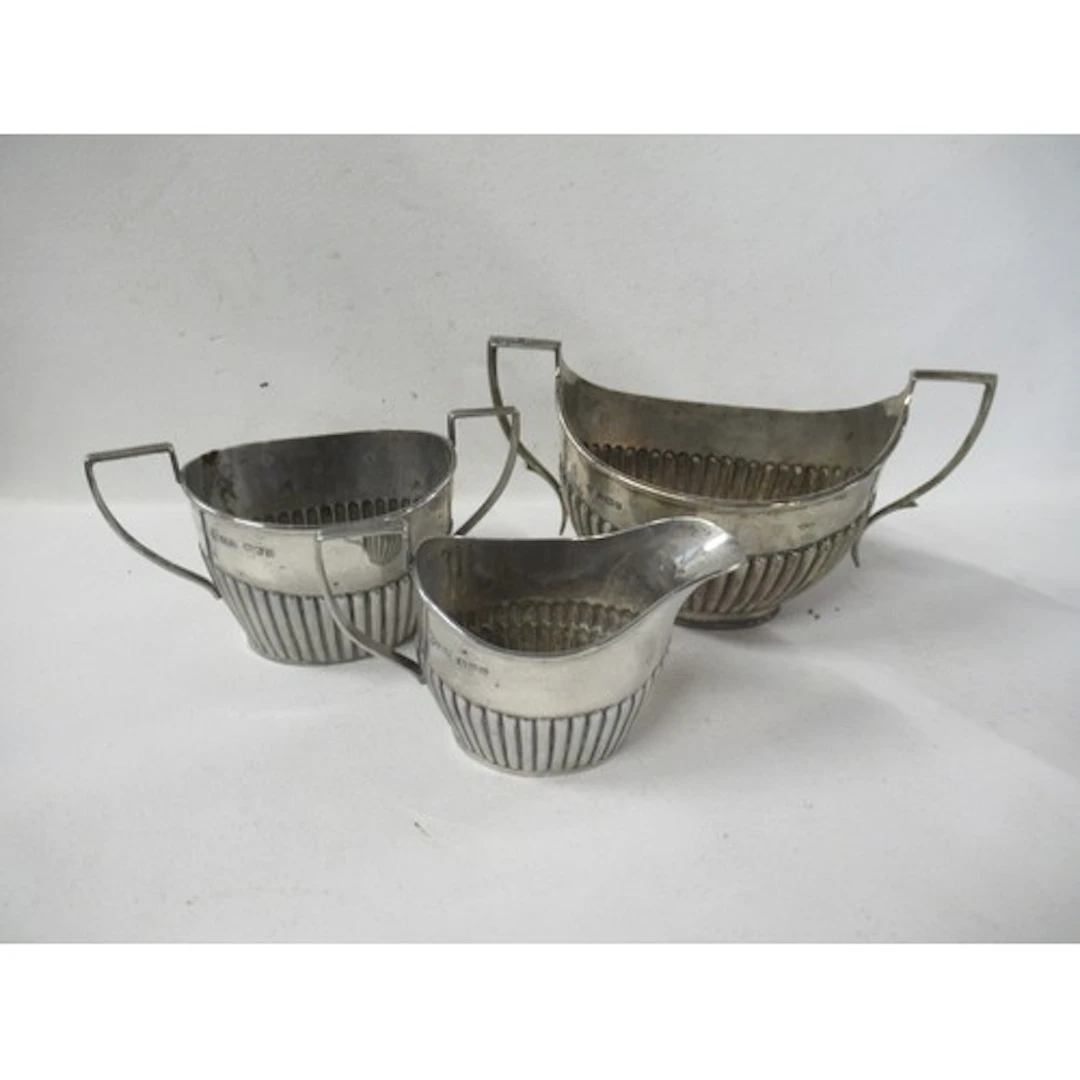 A silver two handled sugar bowl, with reeded lower body, tog...