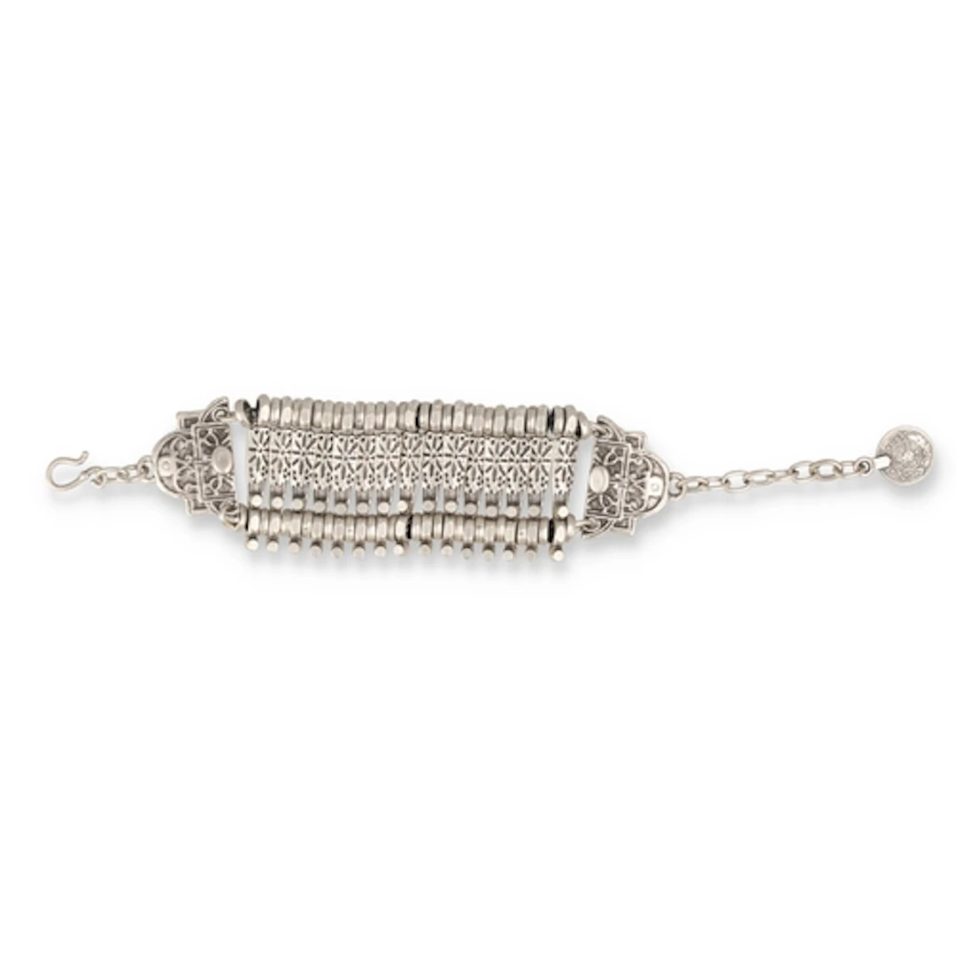 A 20TH C INDIAN OR MIDDLE EASTERN SILVER BRACELET WITH ATTAC...