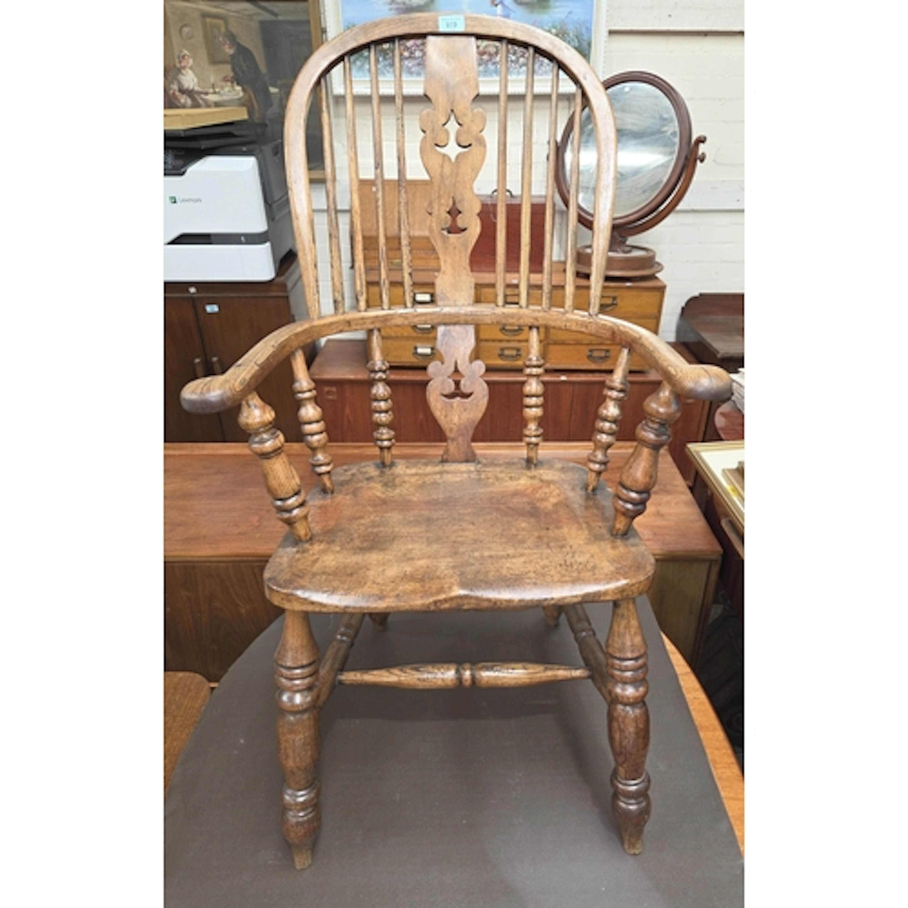 A 19th century yew and elm Windsor chair with pierced vase s...