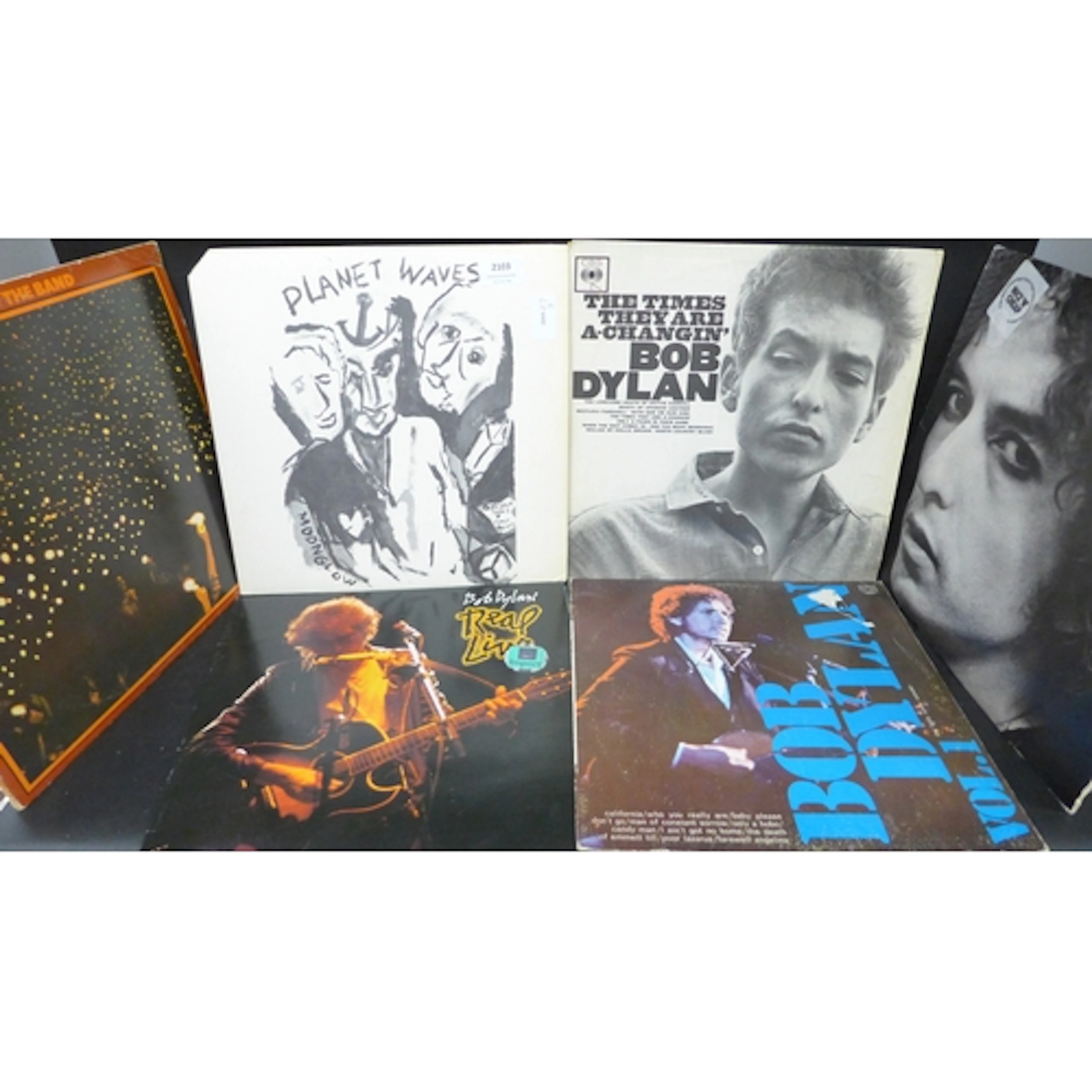 A collection of Bob Dylan and Paul Simon LP records, includi...