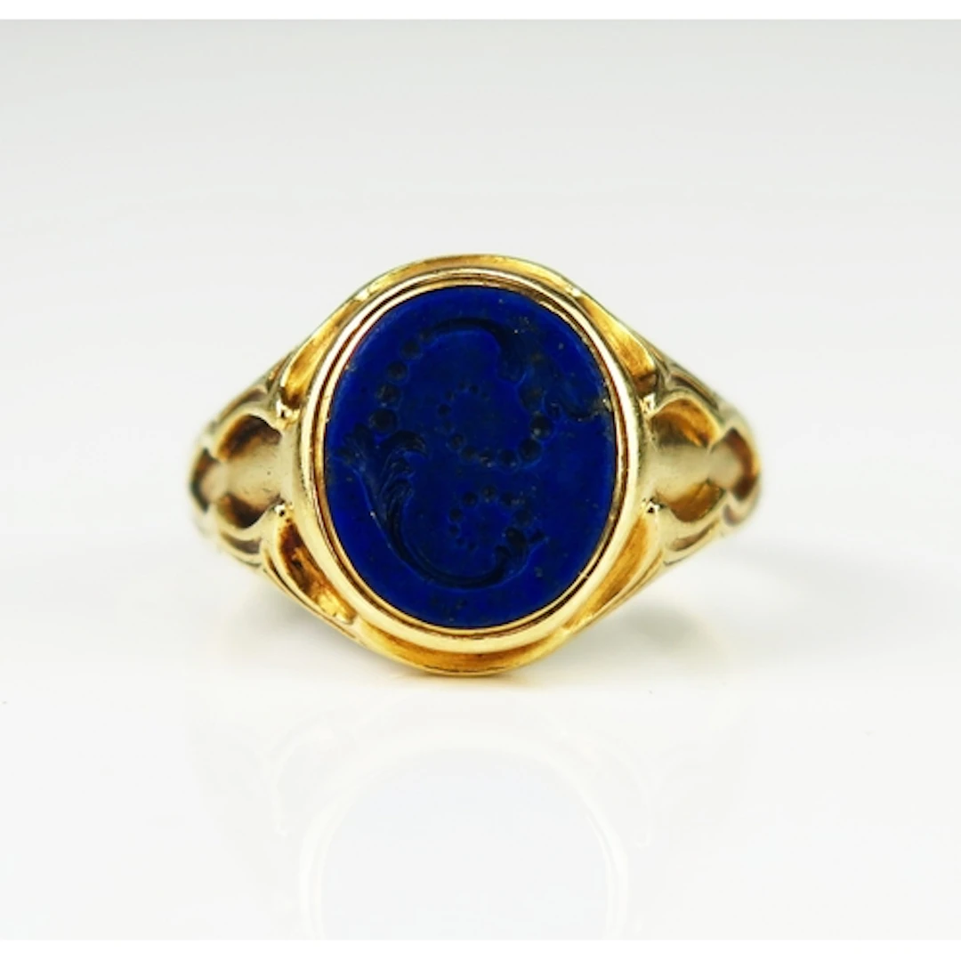 An antique lapis lazuli signet ring engraved with a foliate ...