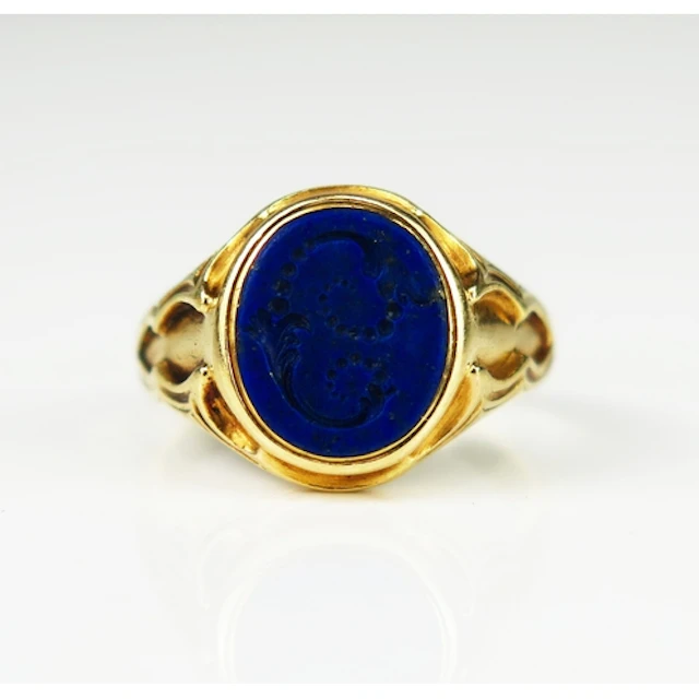 An antique lapis lazuli signet ring engraved with a foliate ...