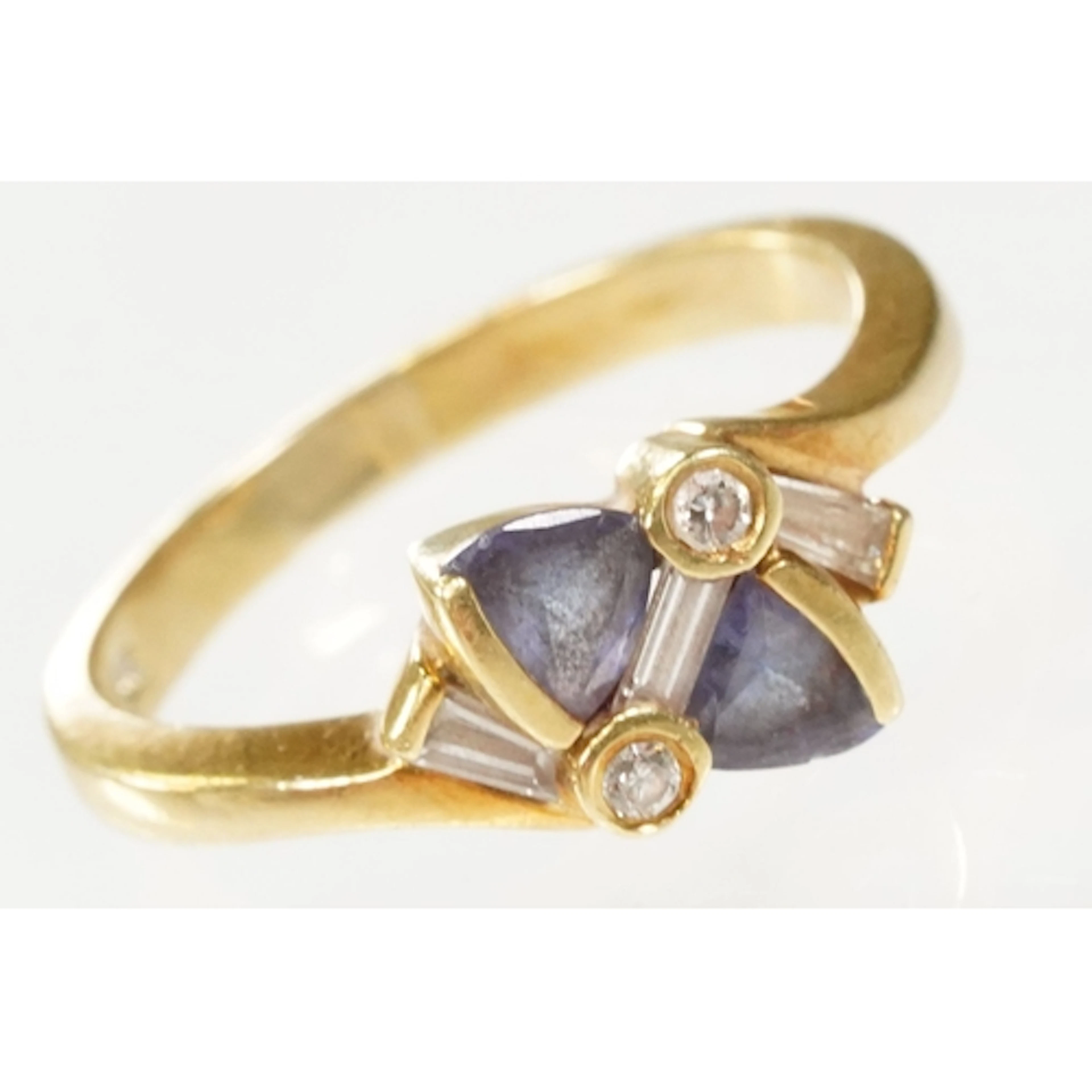 18ct gold, iolite and diamond ring. The ring being set with ...
