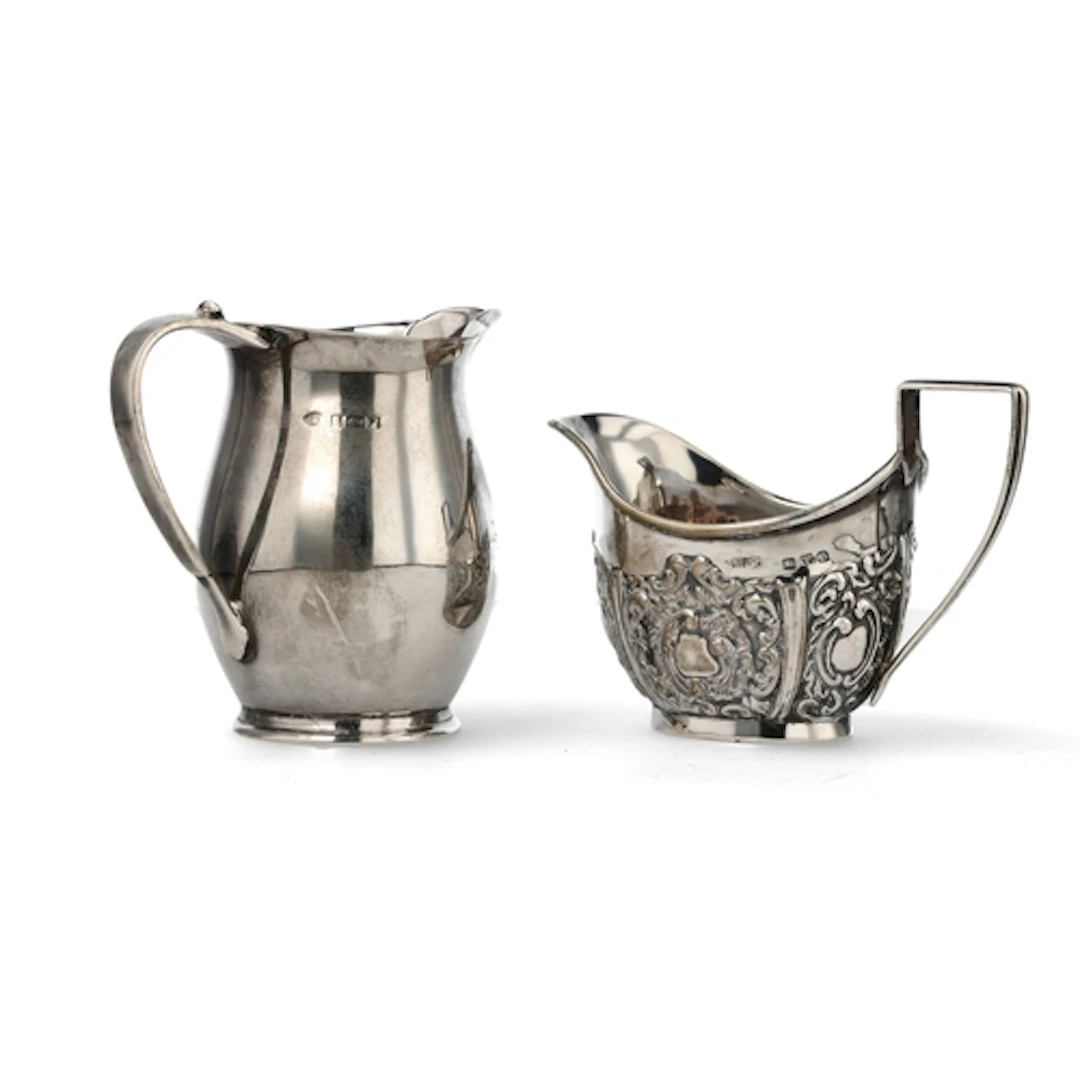 A LATE VICTORIAN SILVER CREAM JUG AND ANOTHER IN MID-18TH CE...