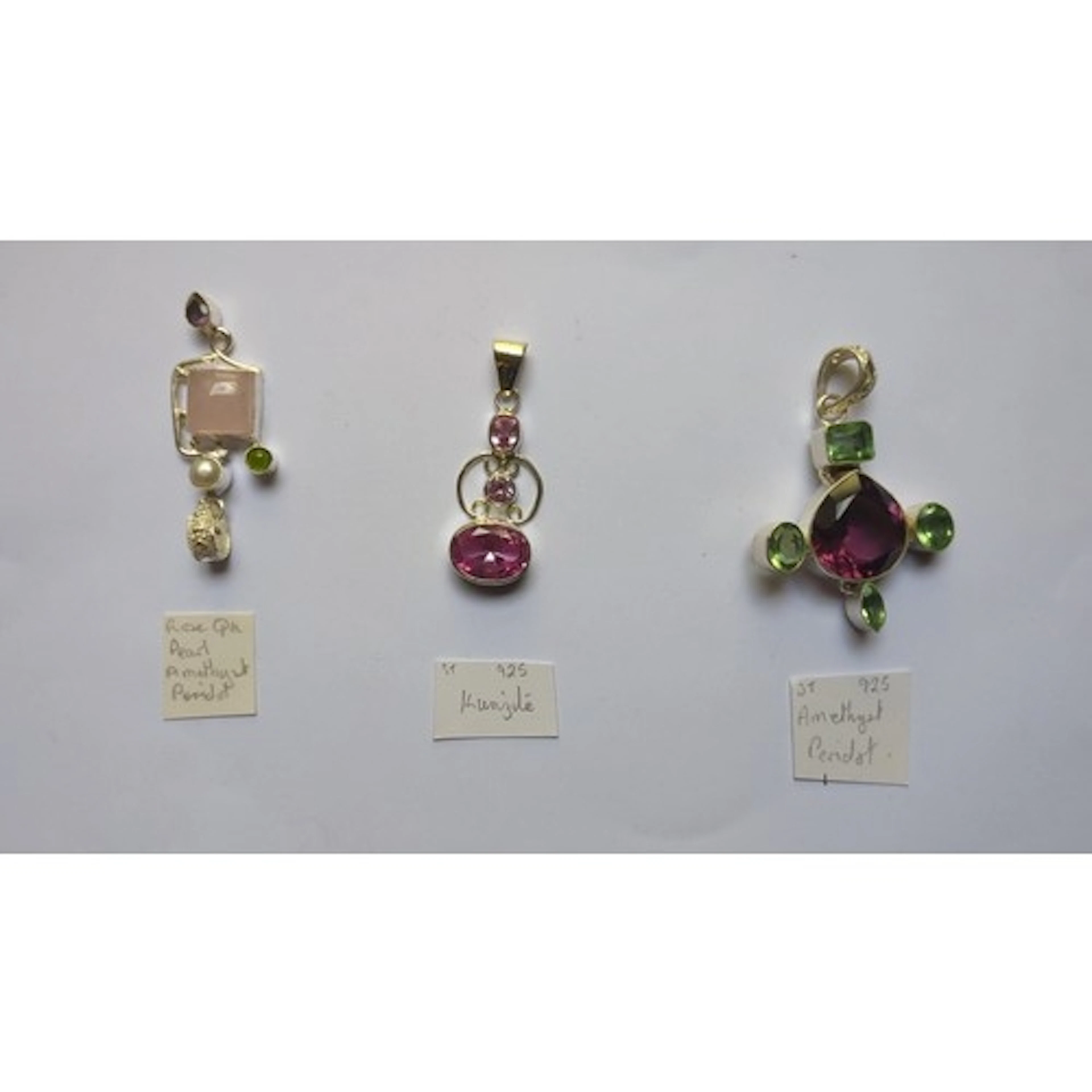 A group of three 925 silver pendants, including a rose quart...