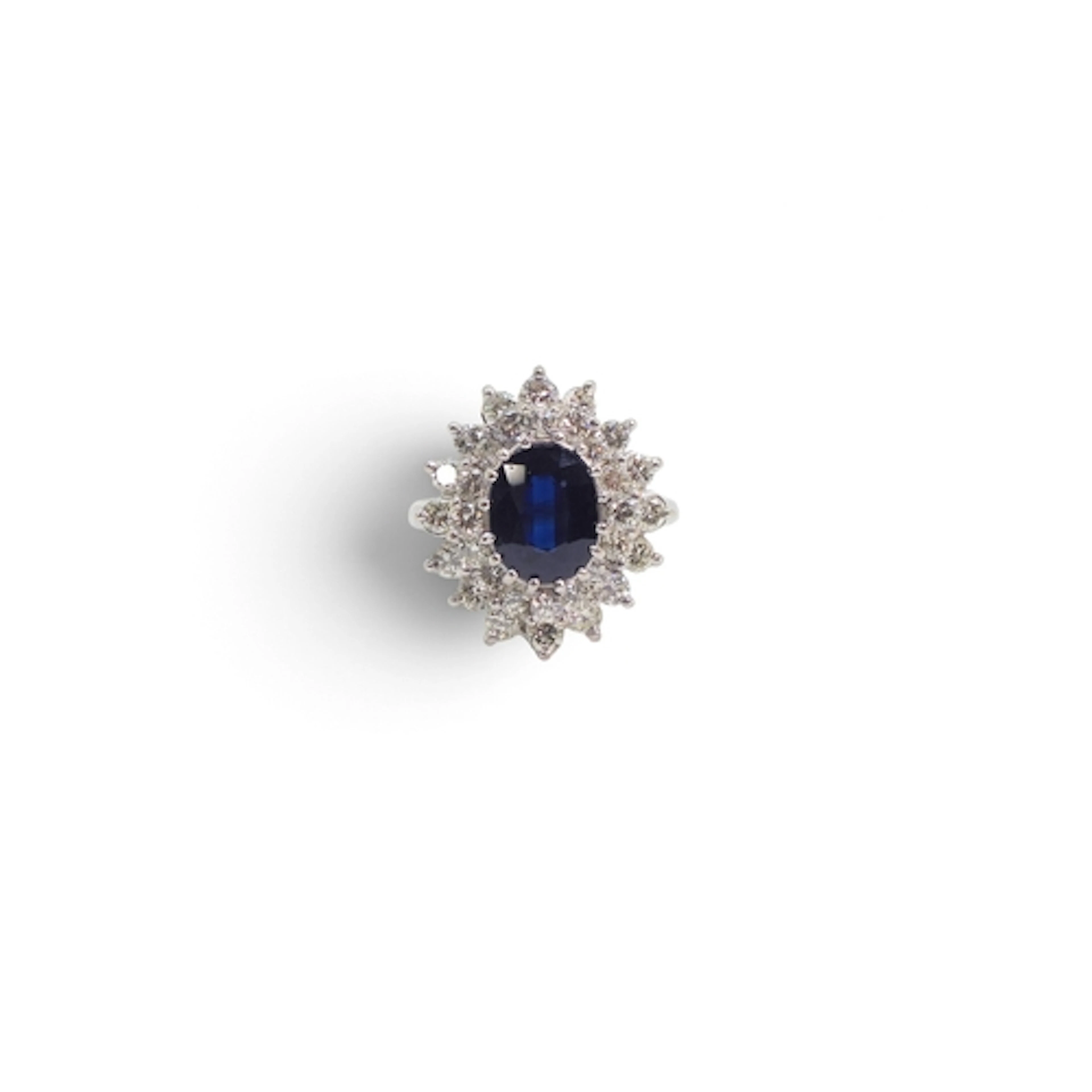 An 18ct white gold sapphire and diamond cluster ring, set wi...