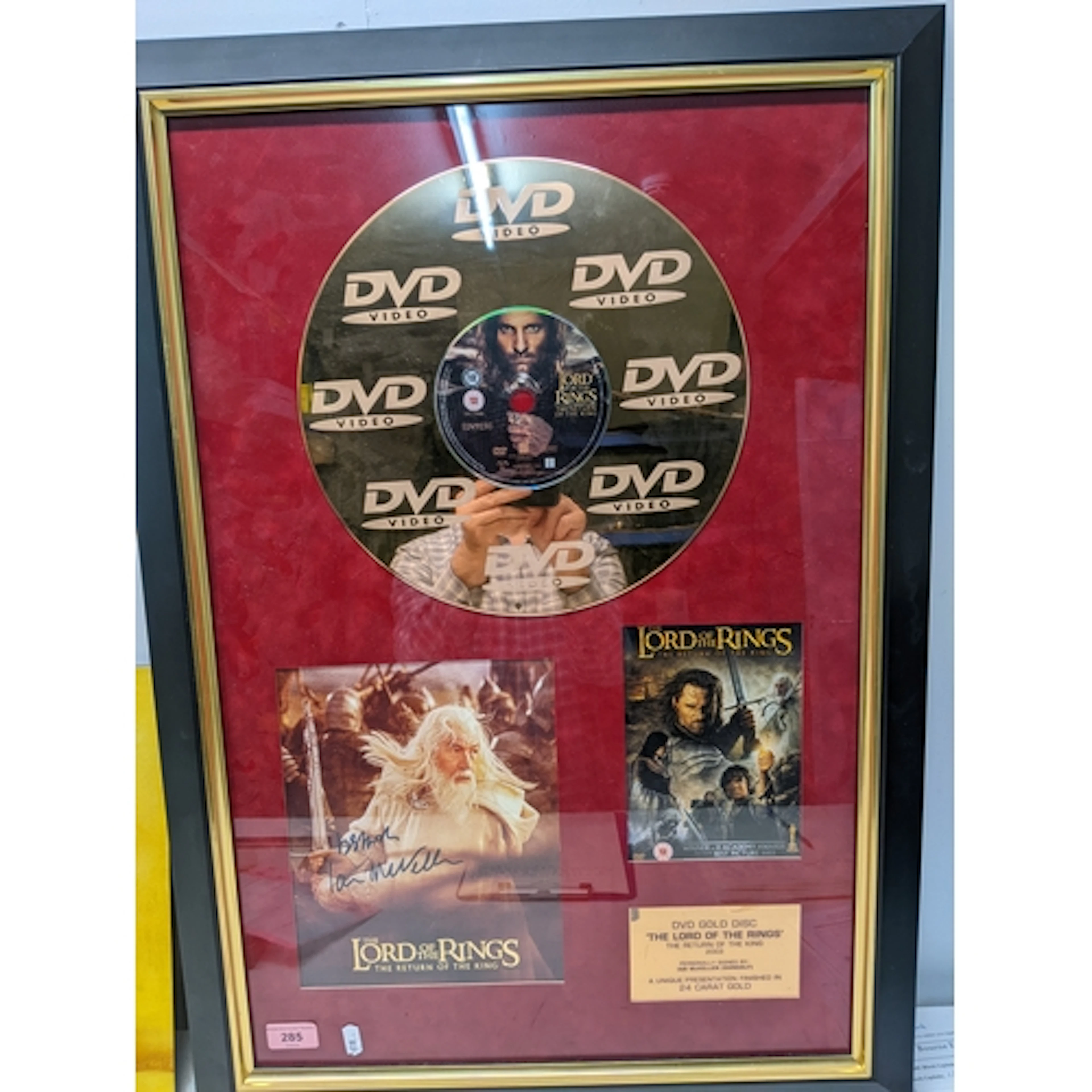 A framed & glazed mounted DVD of the Lord of the Rings - The...