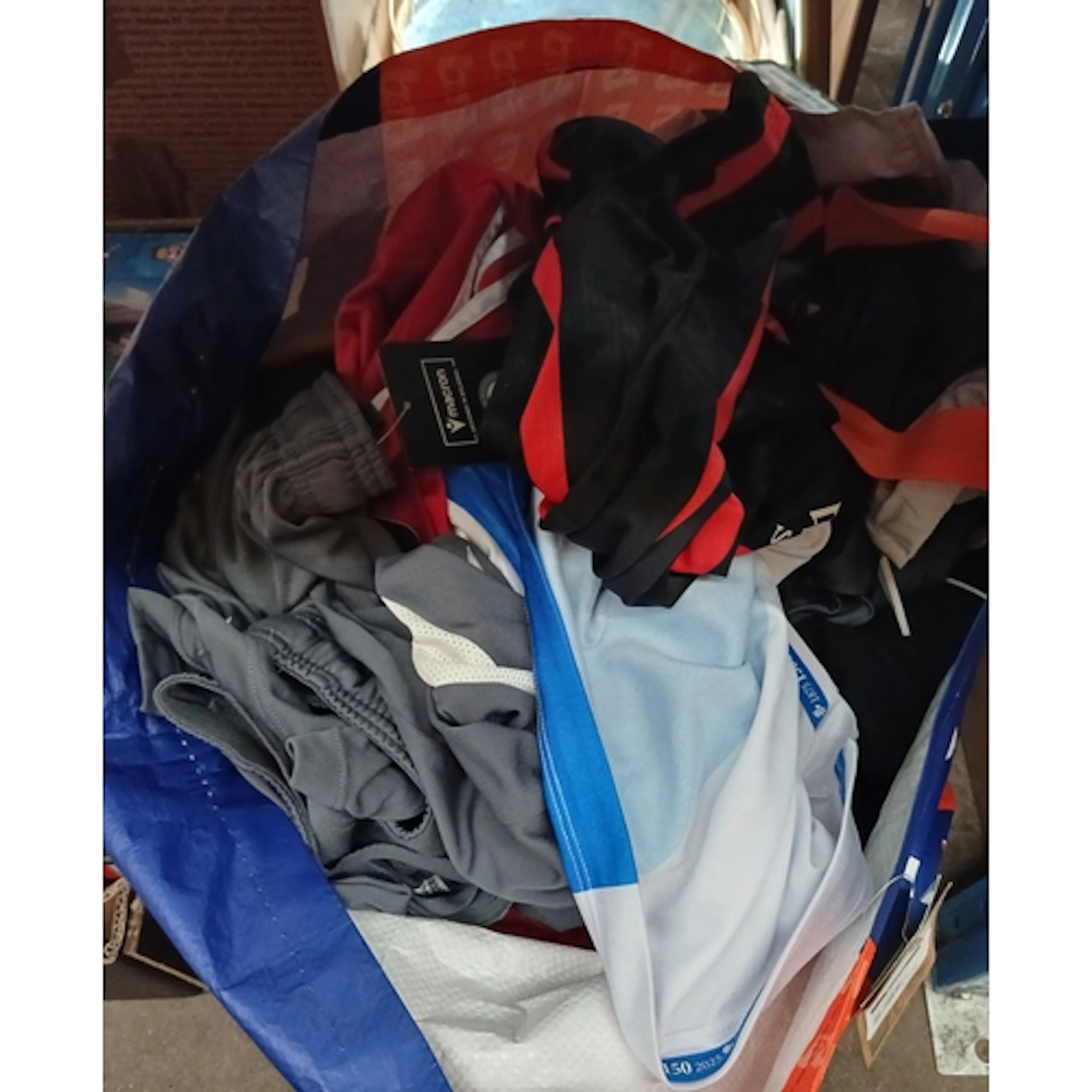 A bag of assorted football clothing, some shirts & shorts, m...