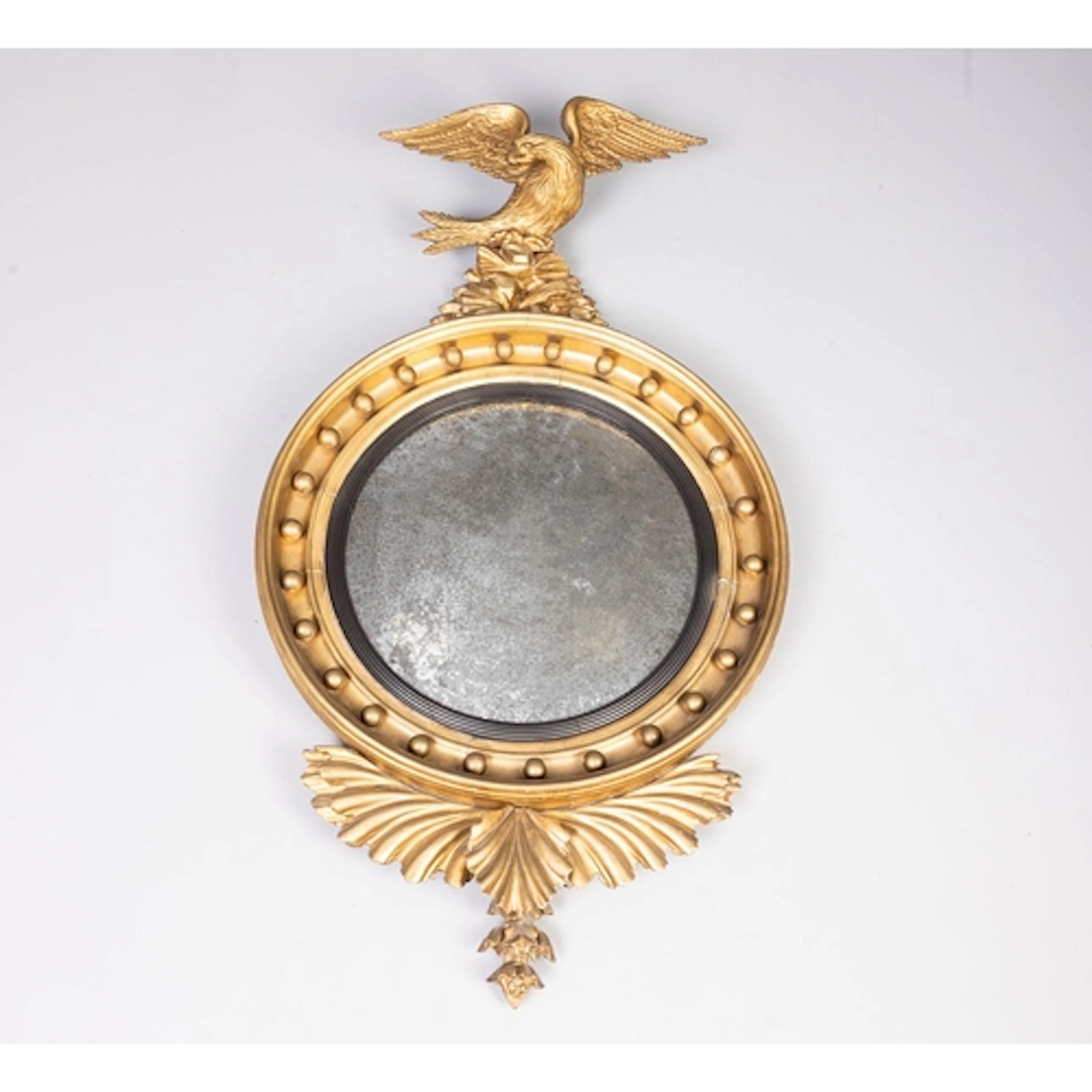 A 19TH CENTURY REGENCY CONVEX WALL MIRROR, EAGLE MOUNT. A 19...