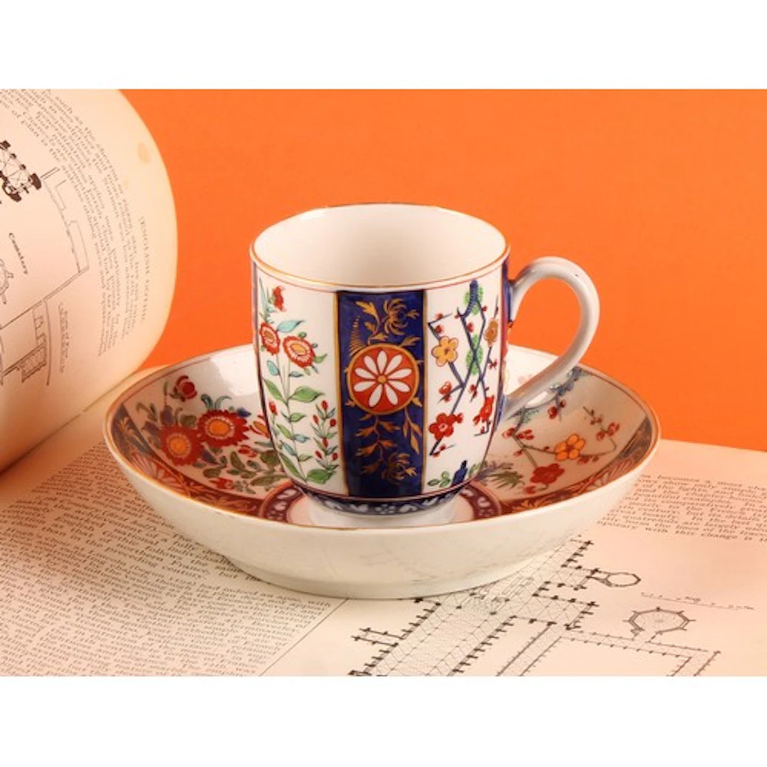 A Worcester Rich Queen's pattern coffee cup and saucer, deco...