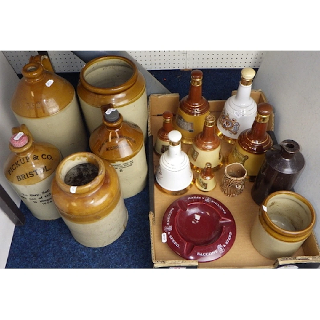 A qty of stoneware flagons & jars together with Bells decant...