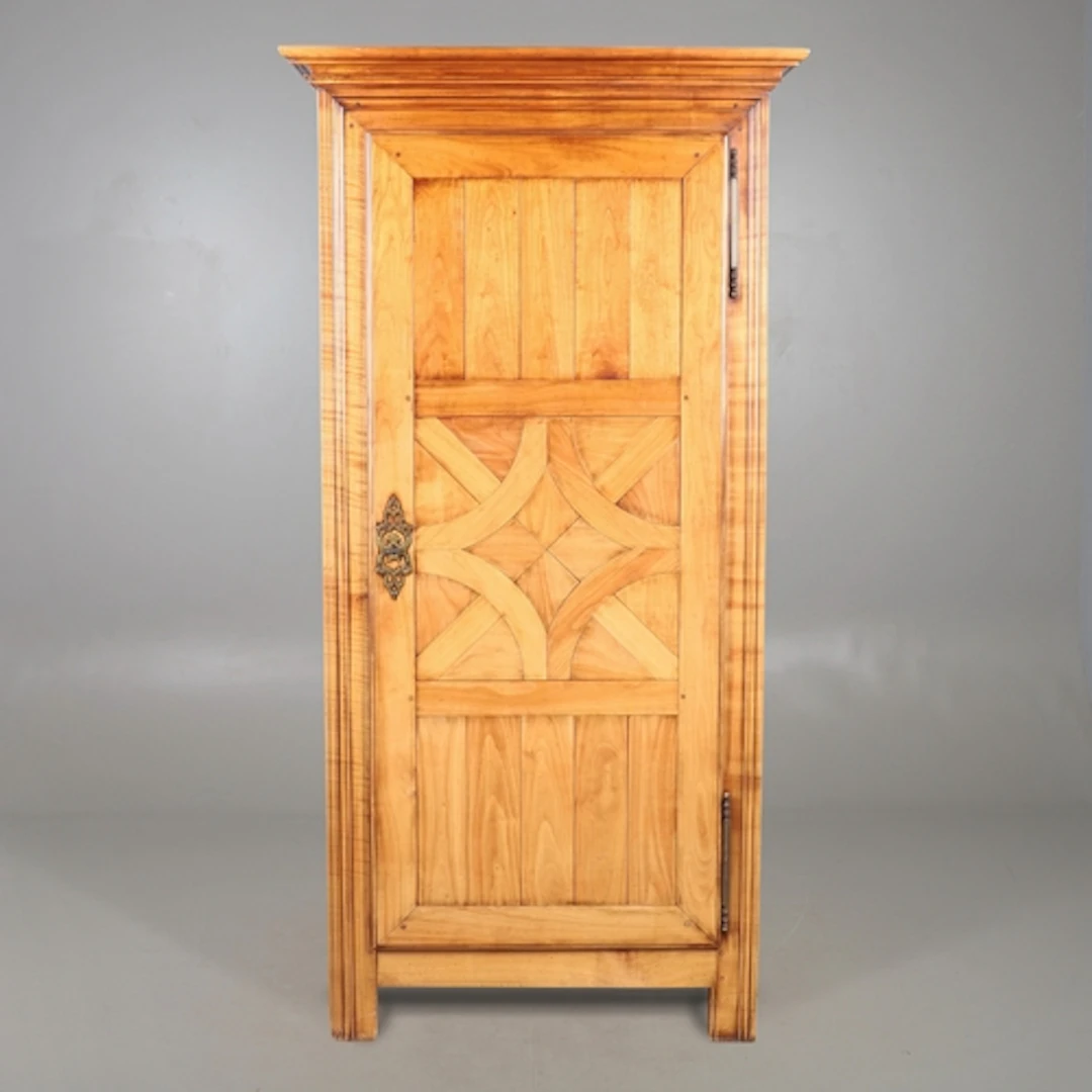 A 20TH CENTURY FRENCH FRUITWOOD ARMOIRE. the single door dec...
