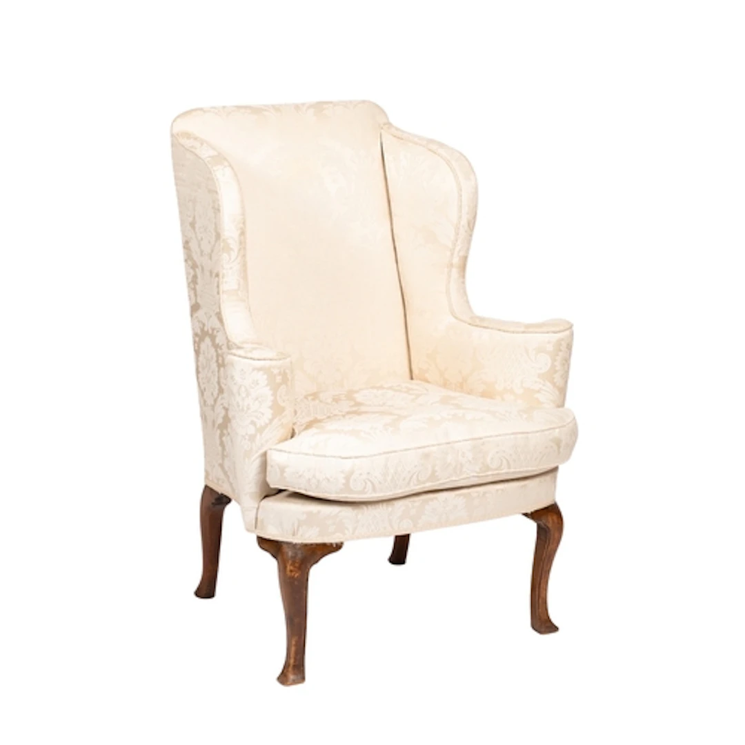 An upholstered wing armchair in Queen Anne style, early 20th...