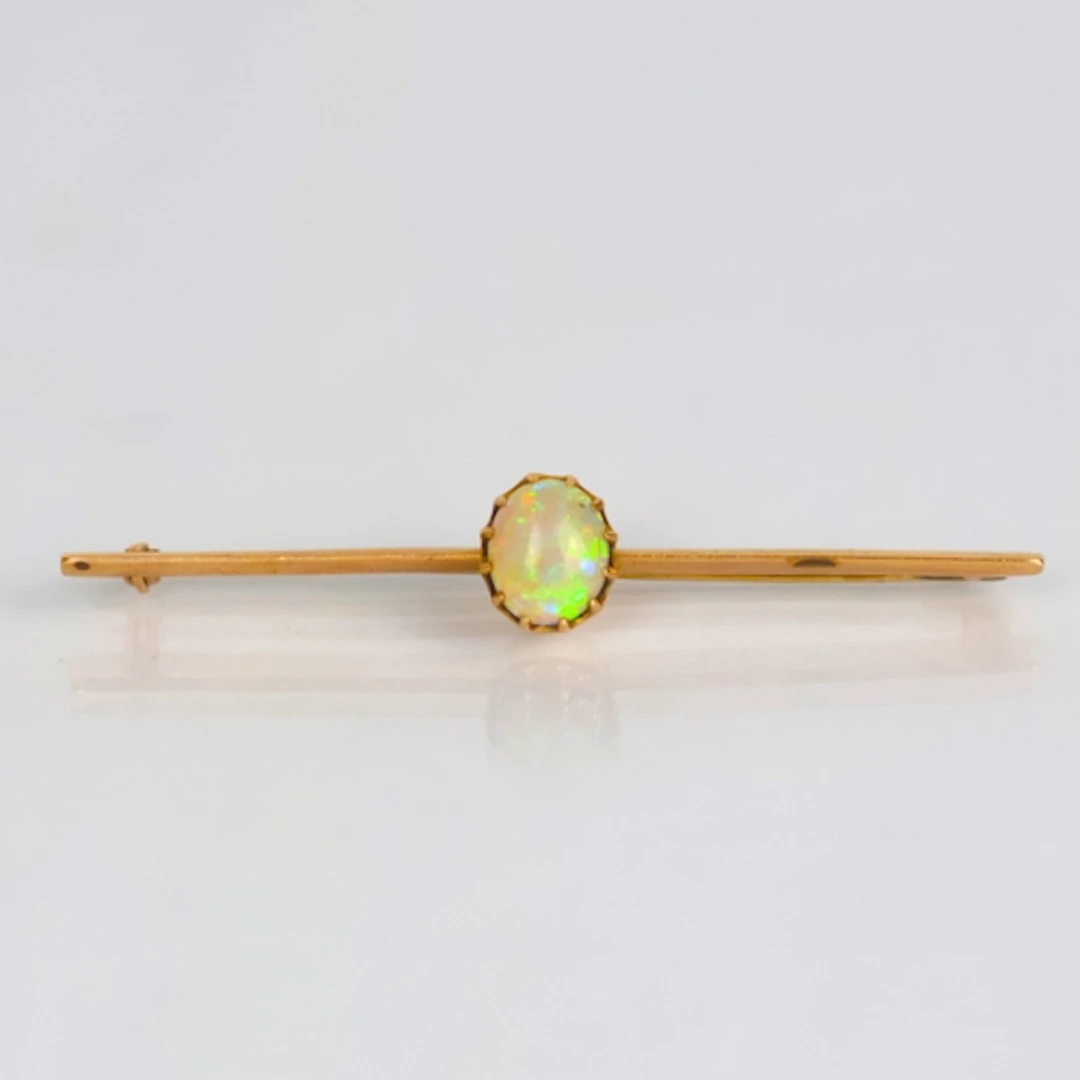 An early 20th century opal bar brooch, the oval opal cabocho...
