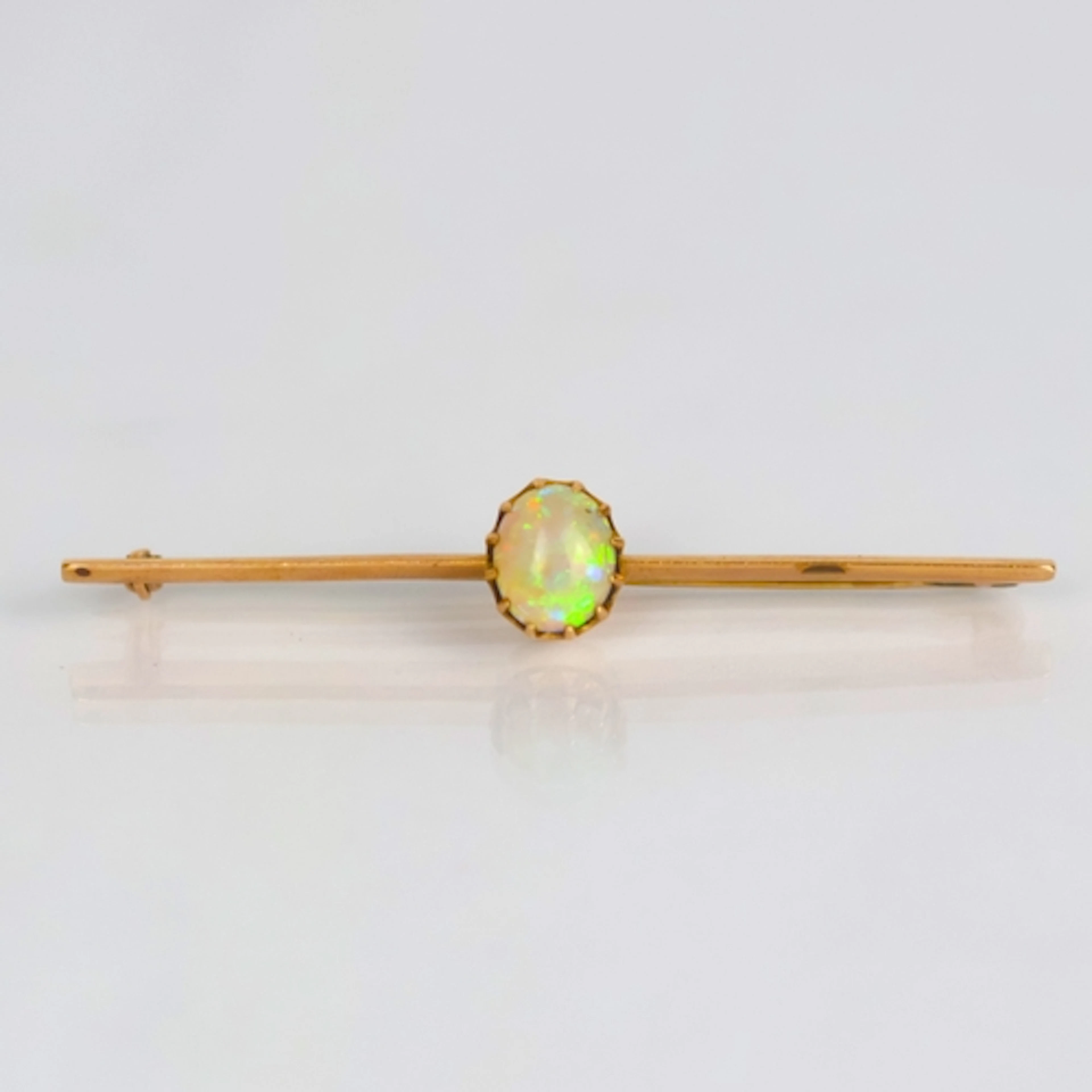 An early 20th century opal bar brooch, the oval opal cabocho...