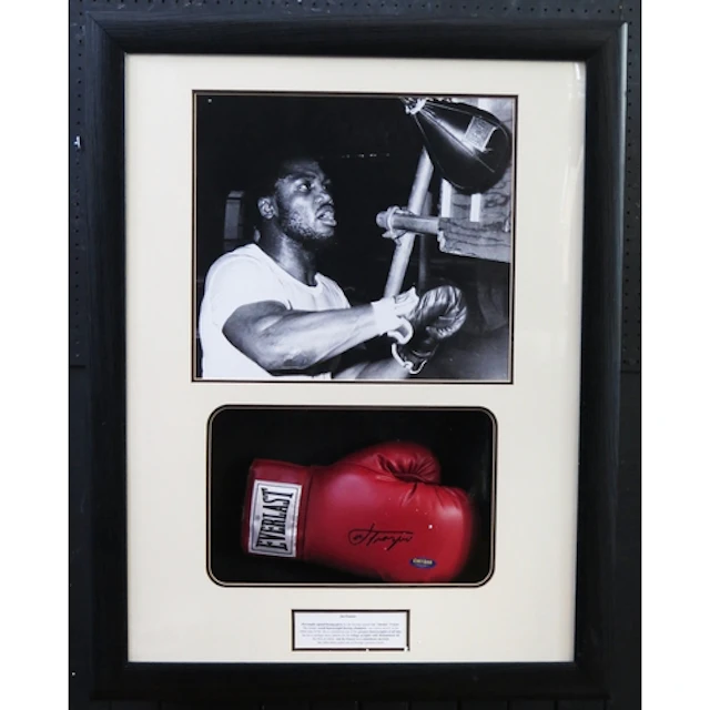 Joe Frazier (smoking Joe) signed boxing glove in a mounted d...