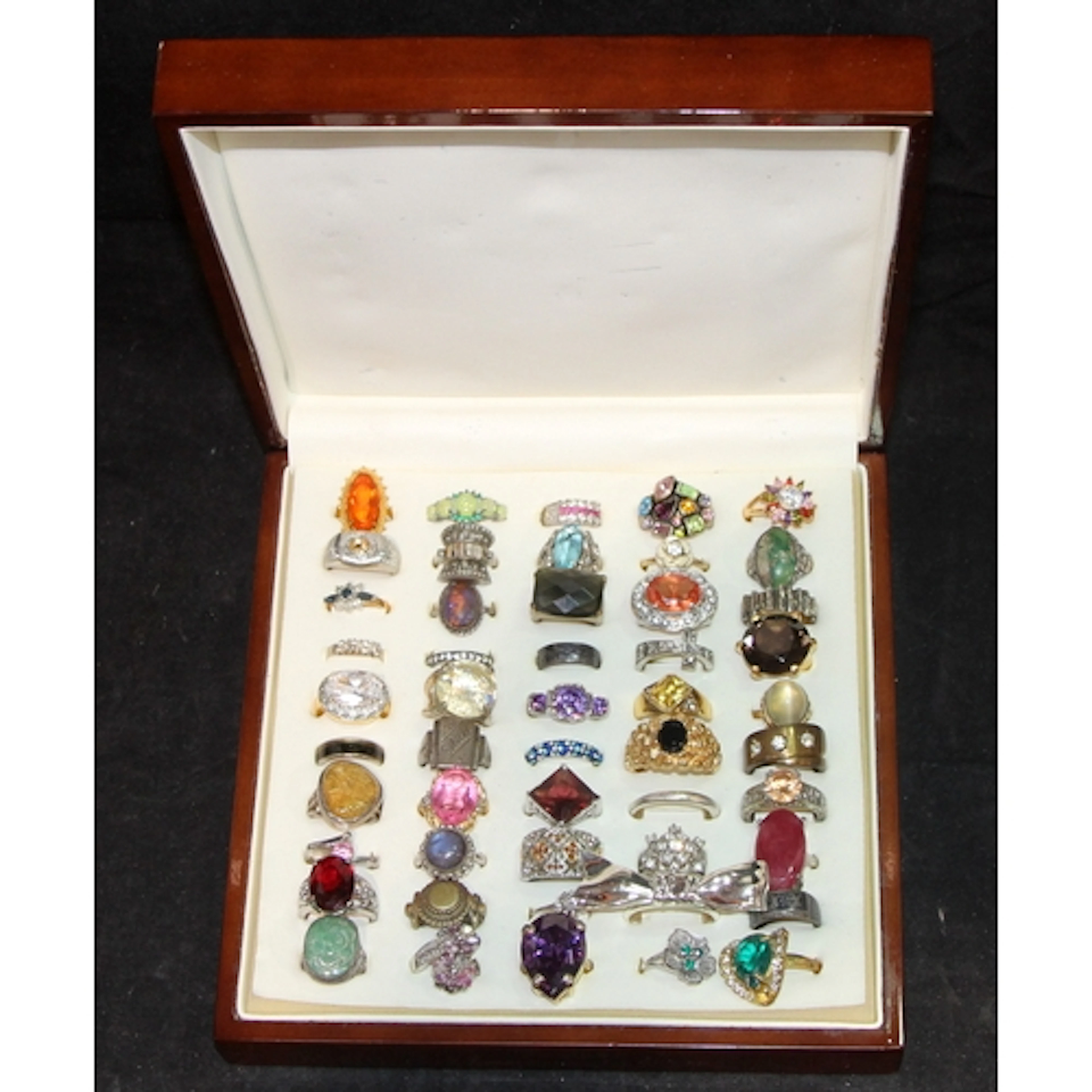 A selection of costume jewellery fashion rings presented in ...