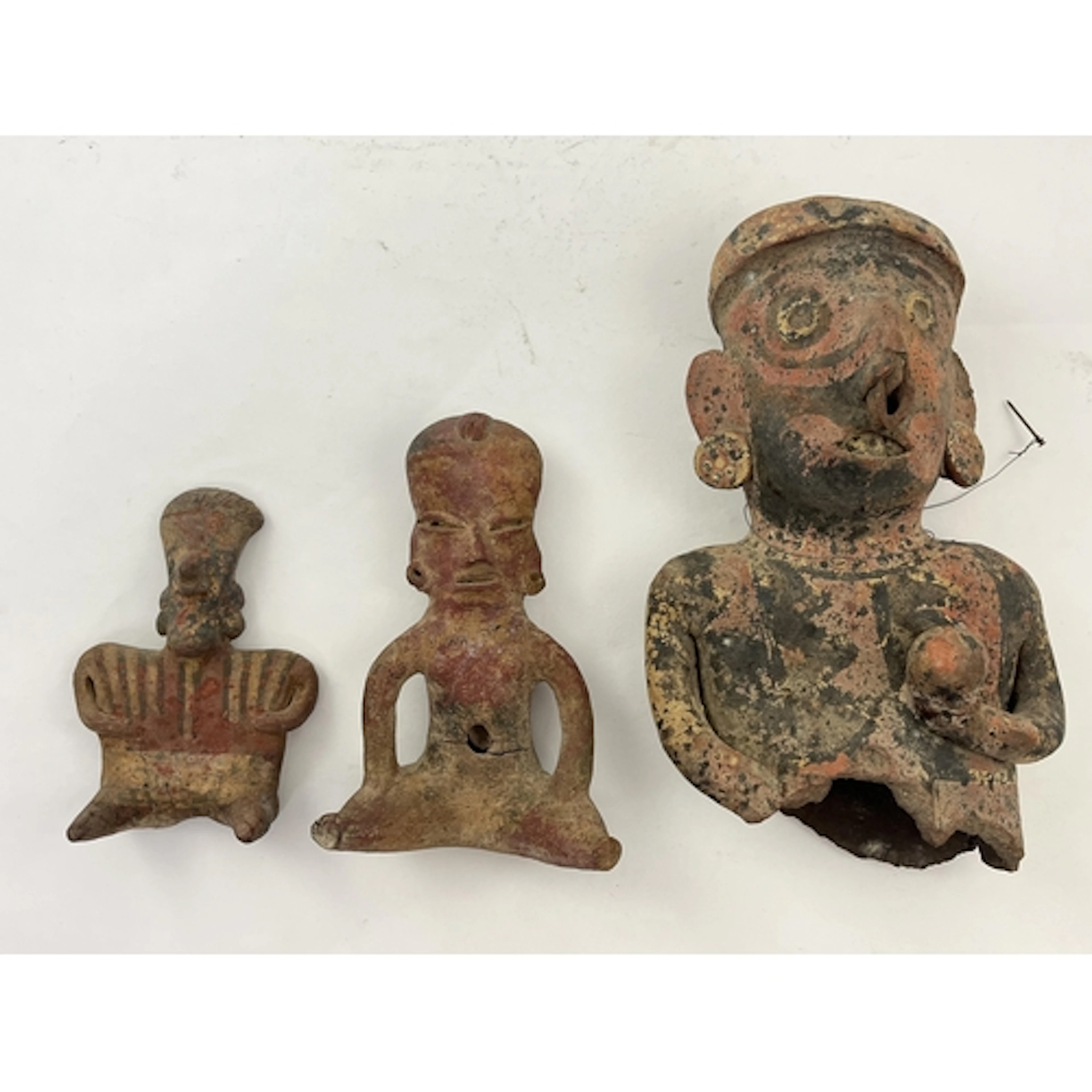 A group of three Pre-Columbian Nayarit polychrome seated fig...