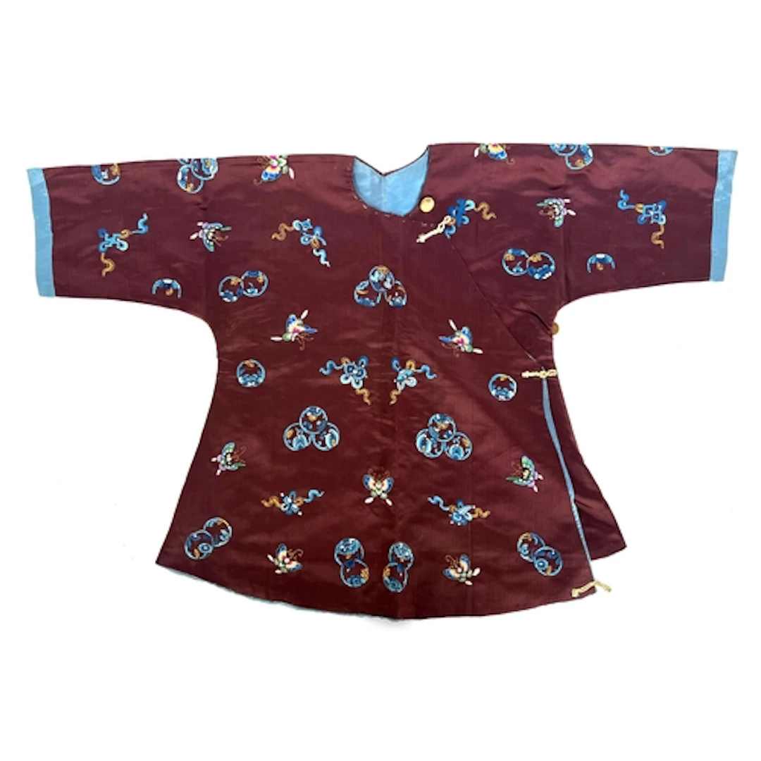 An antique Chinese silk child's robe, brown silk with blue a...