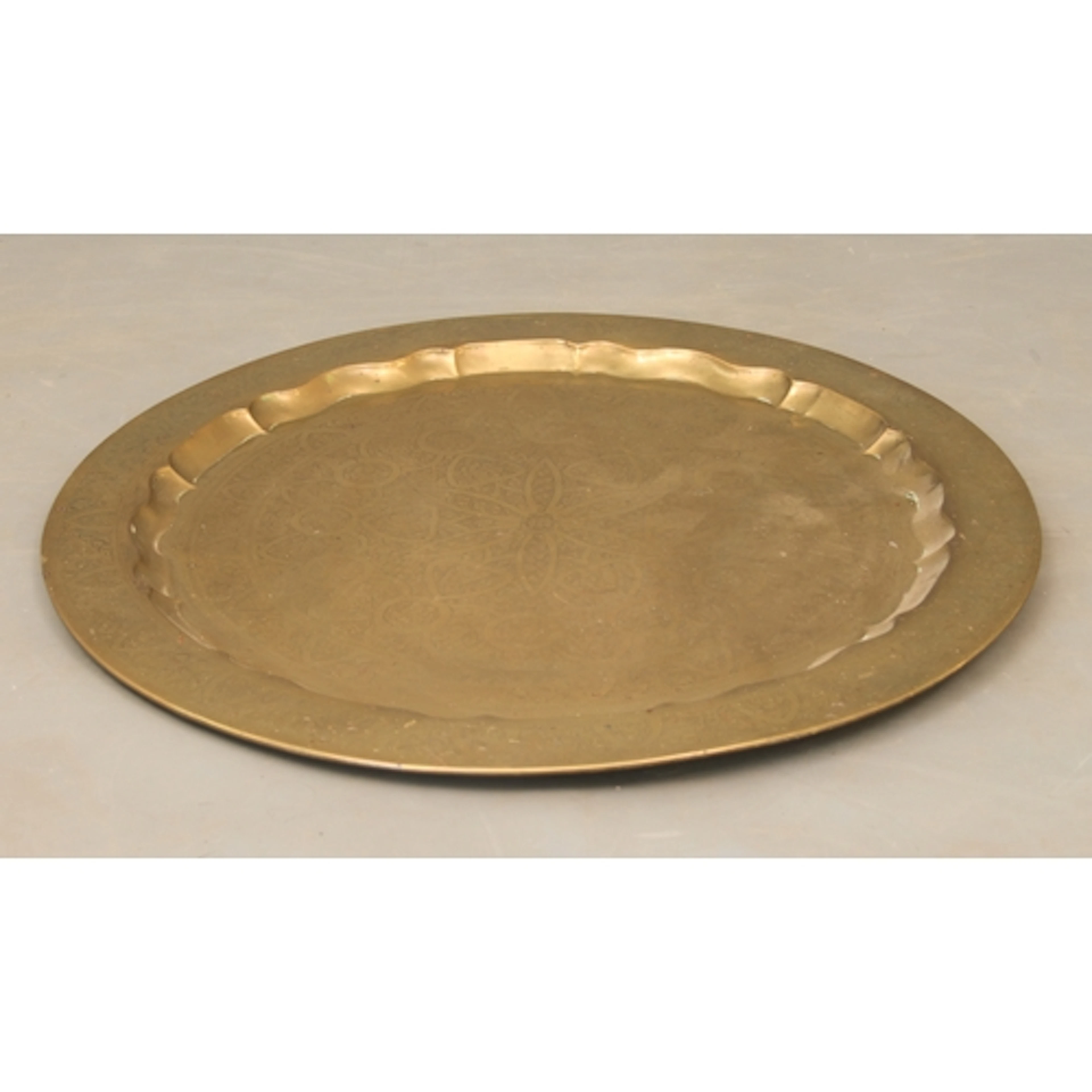 A large antique Eastern circular brass tray - the well and l...
