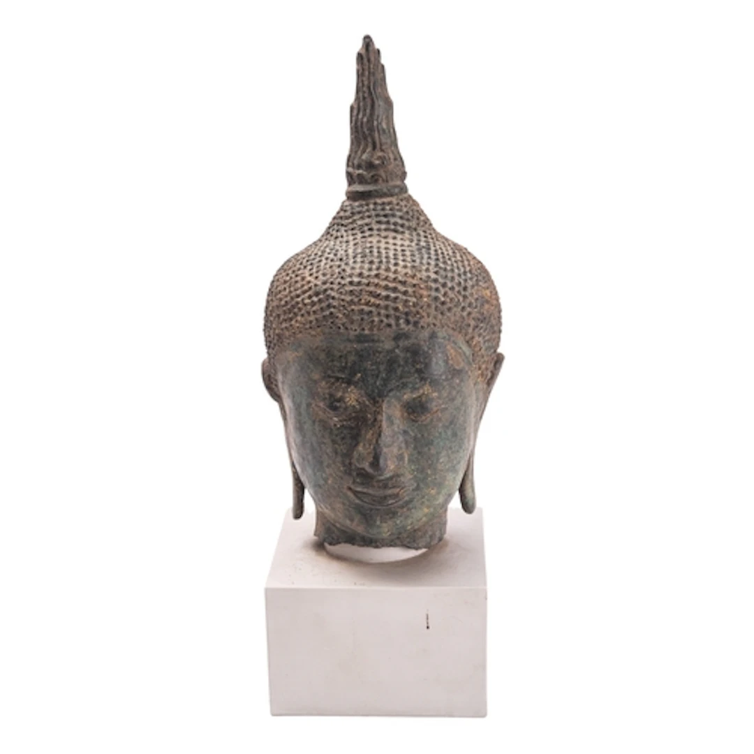 A Thai bronze head of Buddha with curled hair, serene expres...