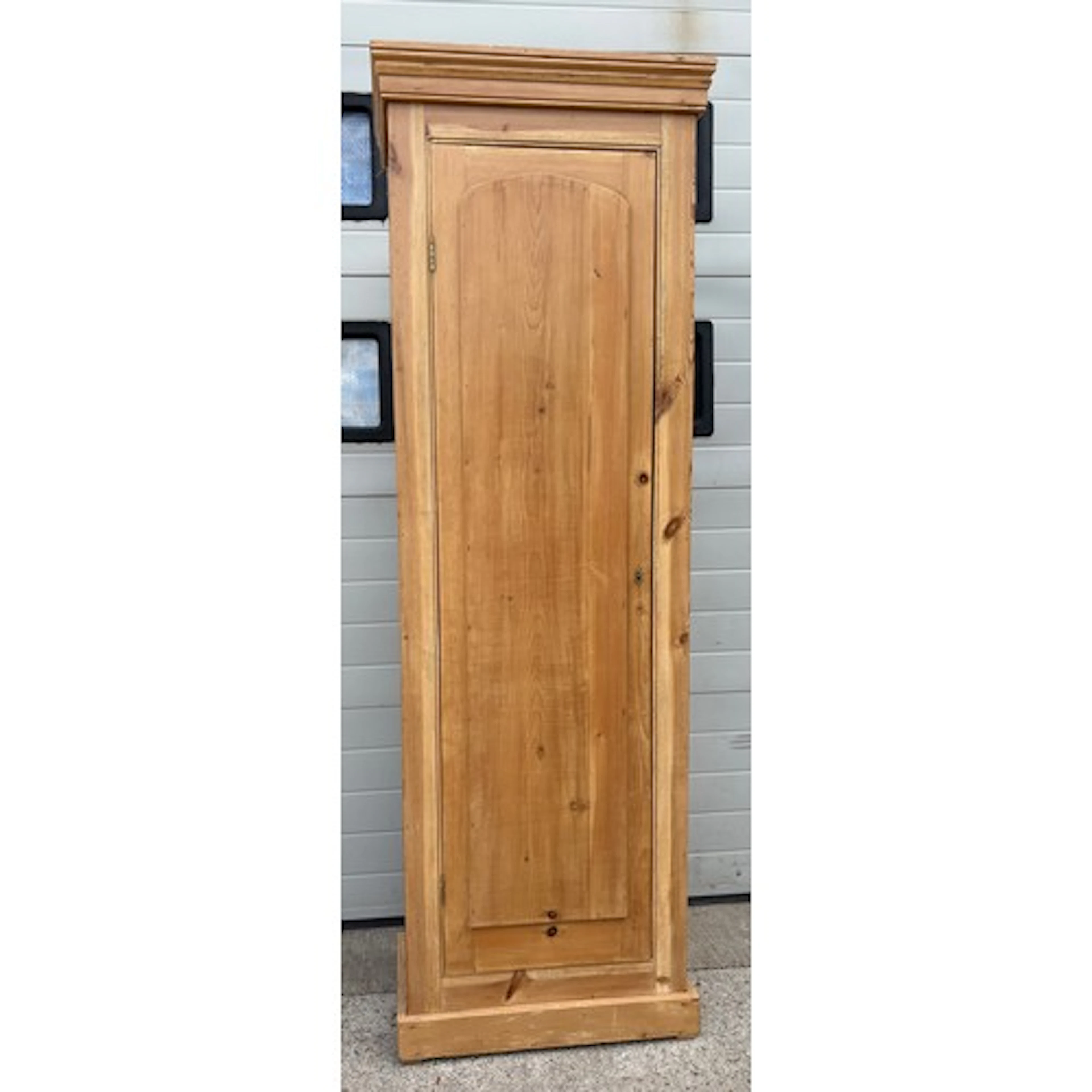 A tall narrow pine hall wardrobe