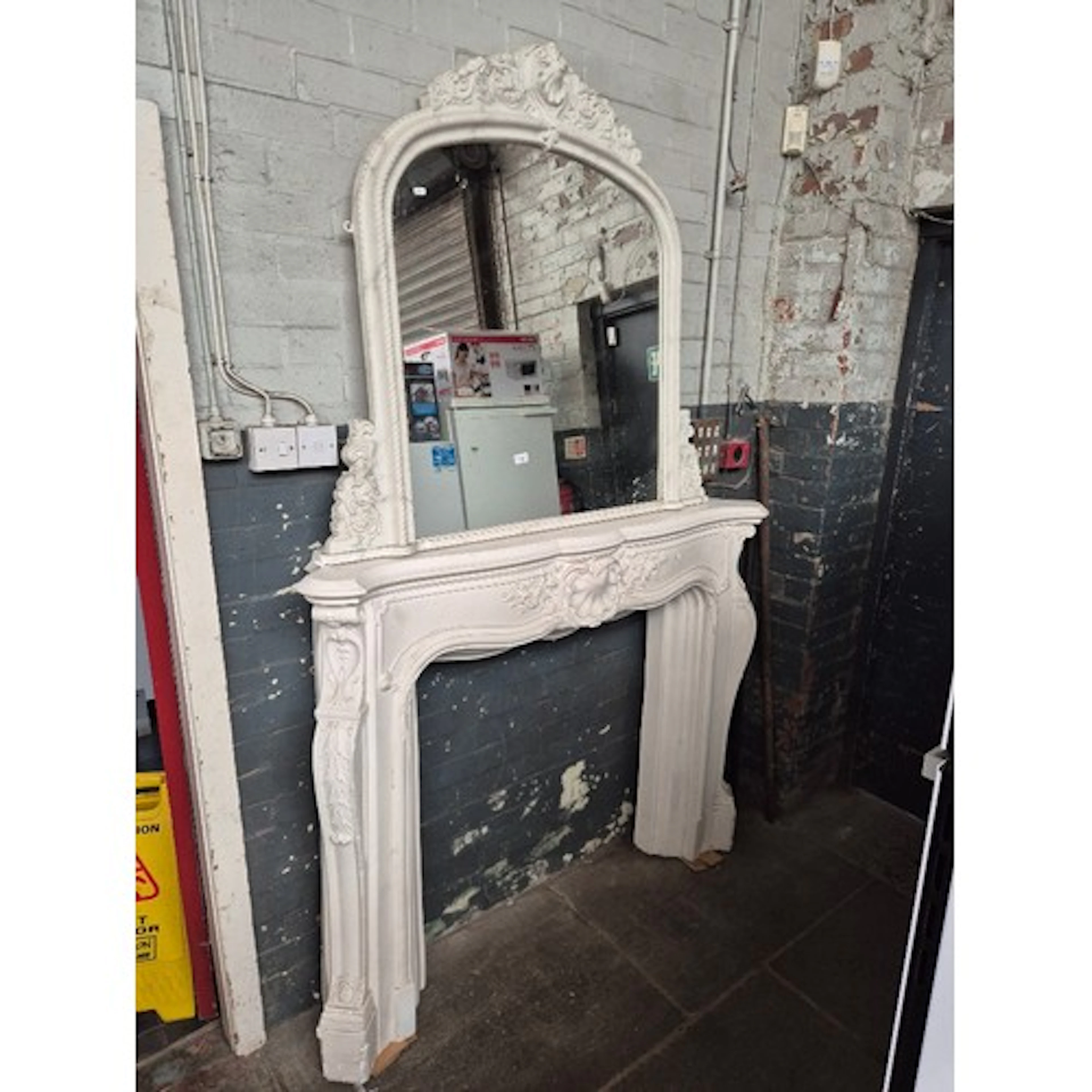 A plaster fireplace surround with seashell cartouche, togeth...