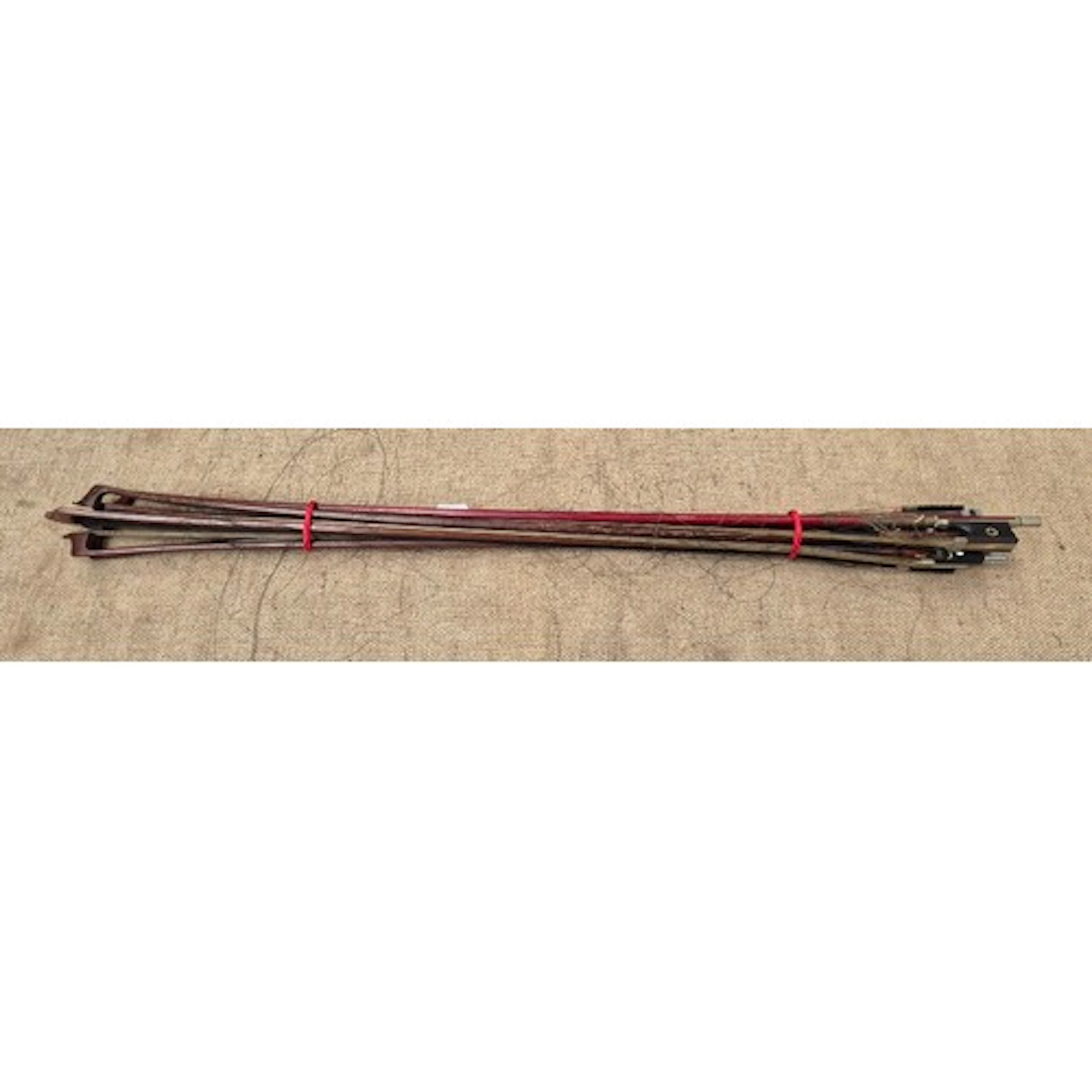 A bundle of antique/vintage violin bows.