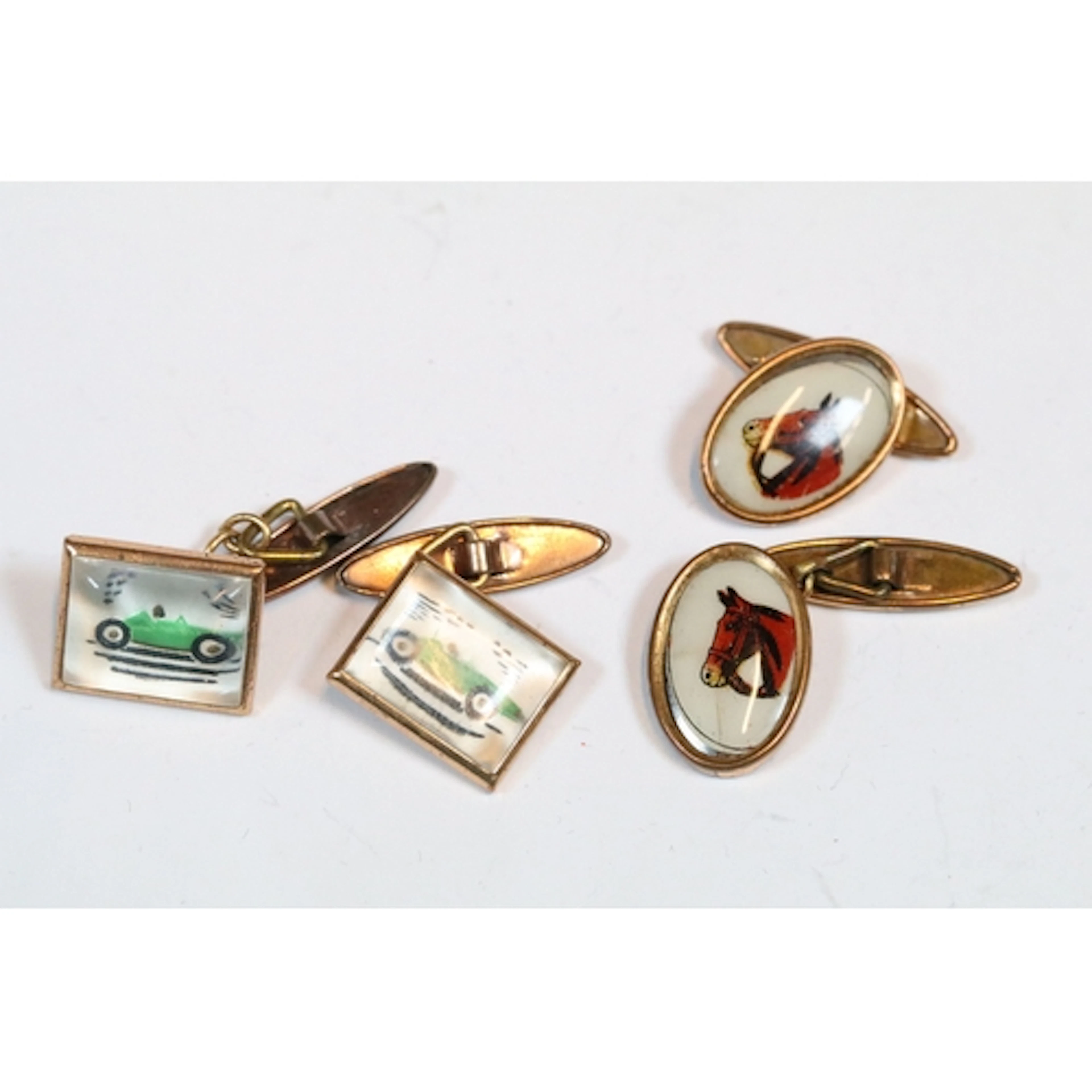 Two pairs of vintage gilt cuff links with racing cars and ho...