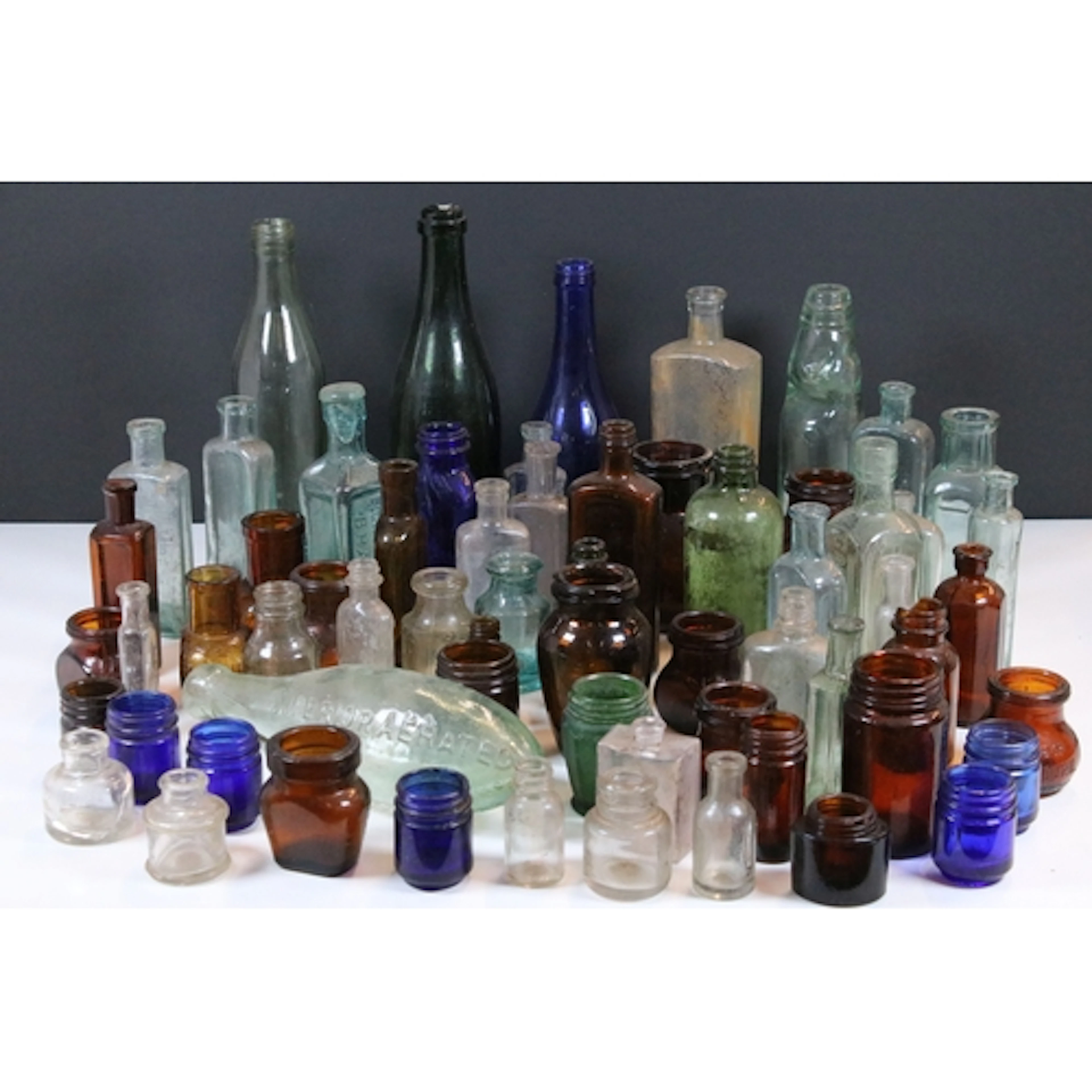 Collection of antique and later glass bottles, comprising va...