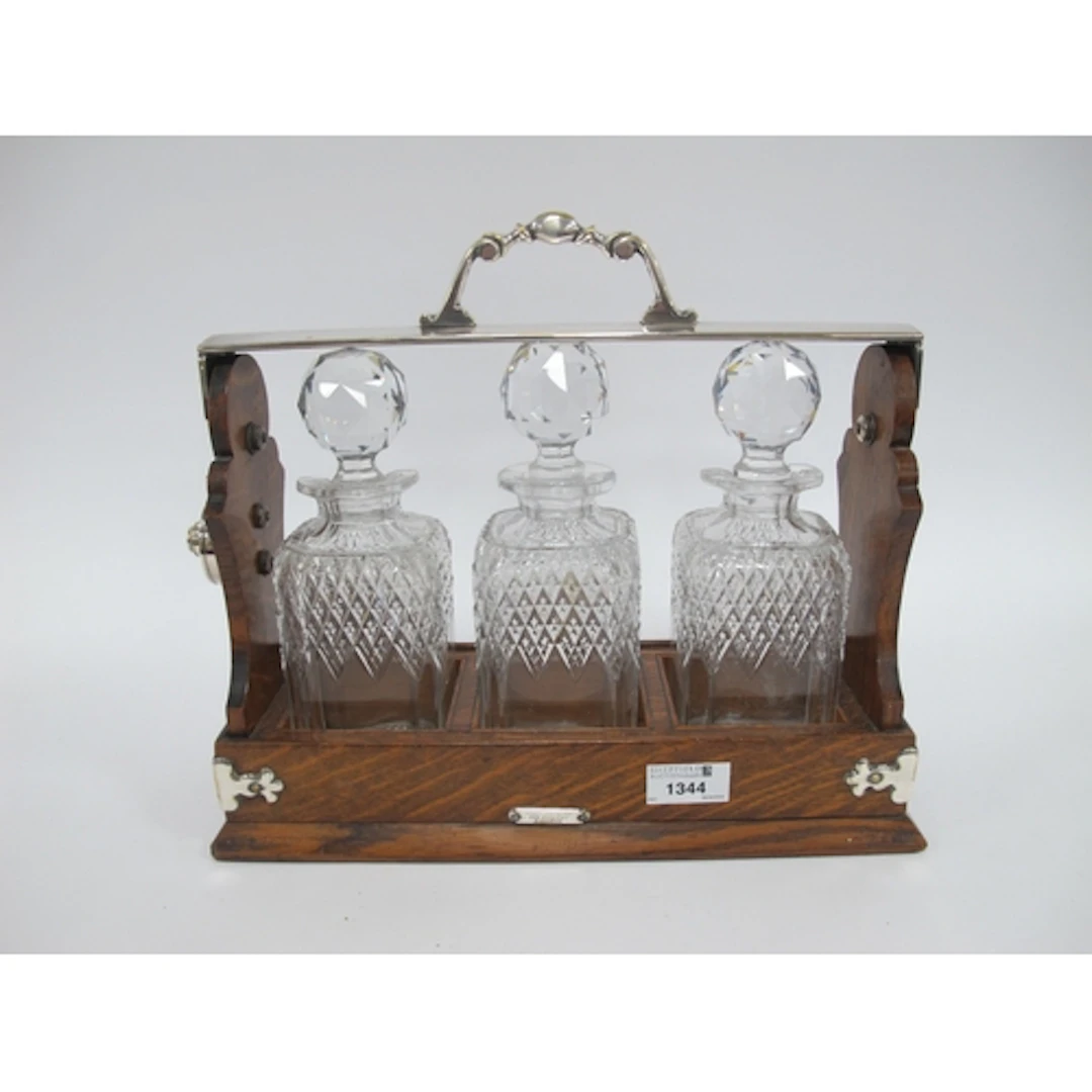 A Victorian Three Bottle Oak Tantulus - three cut glass deca...