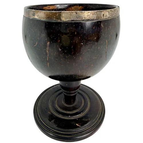 An early 19th-century silver-mounted coconut goblet, the pol...