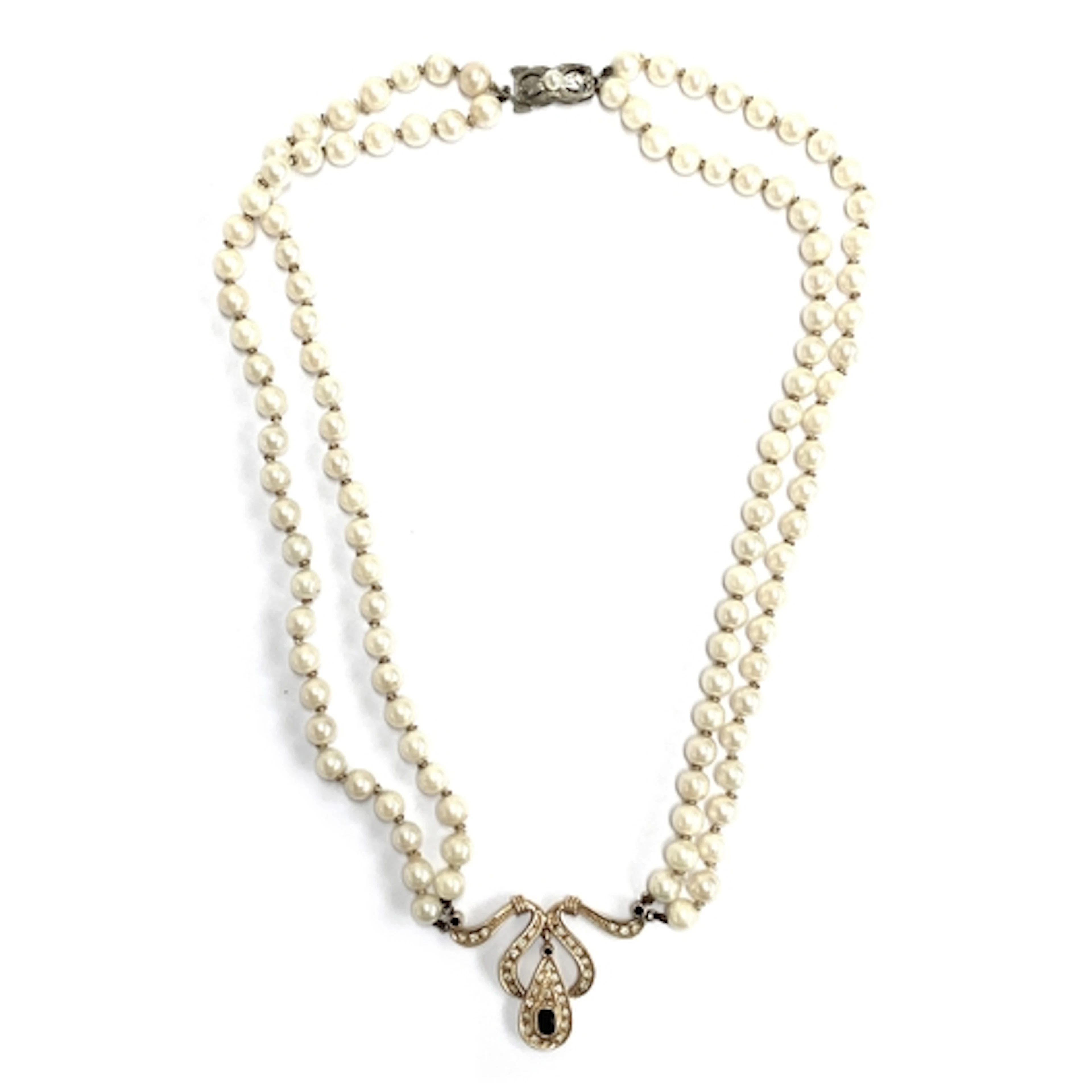 A vintage double strand pearl necklace, with central gold, d...
