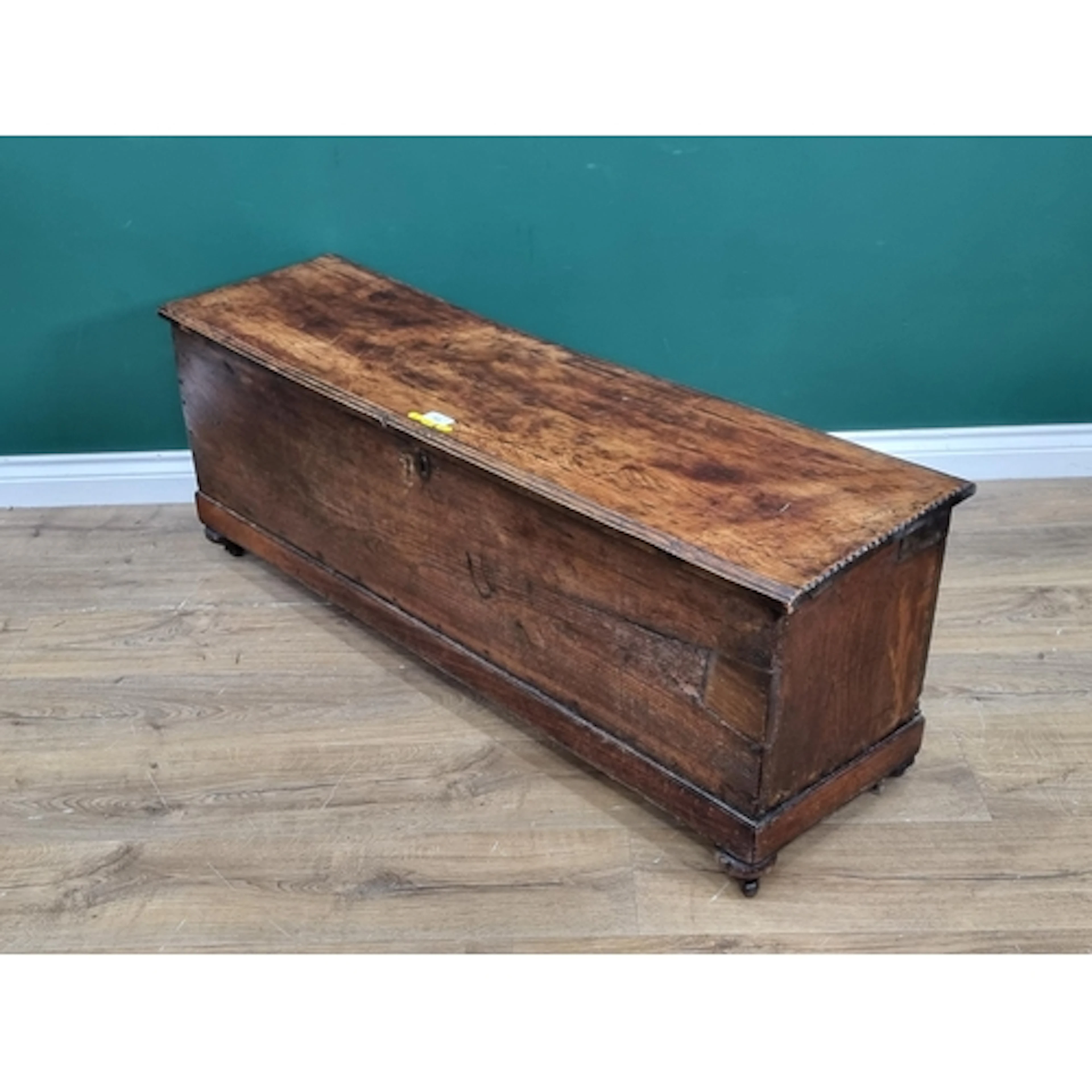 An antique elm Sword Chest with moulded hinged top enclosing...