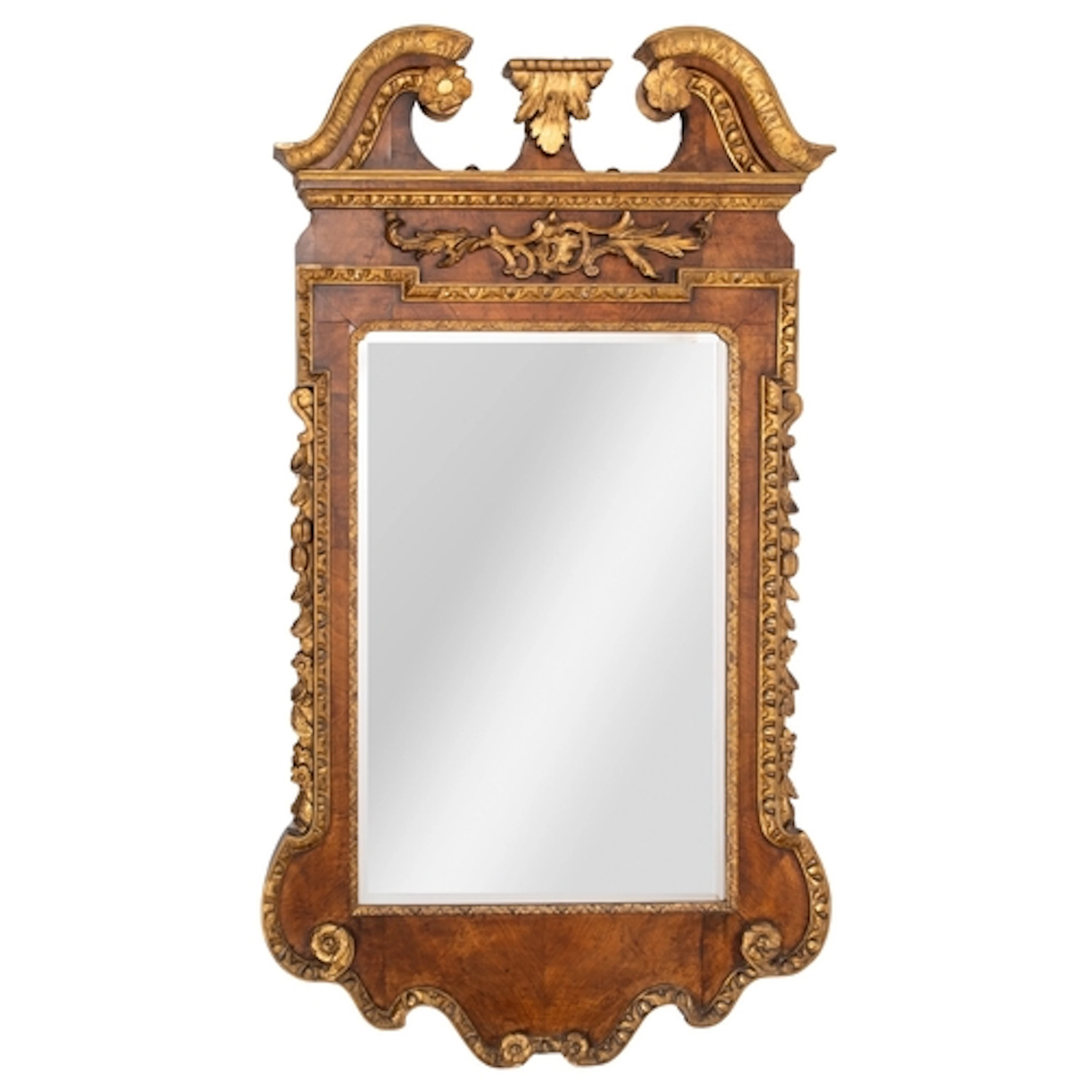 A walnut and parcel gilt framed wall mirror in George II sty...