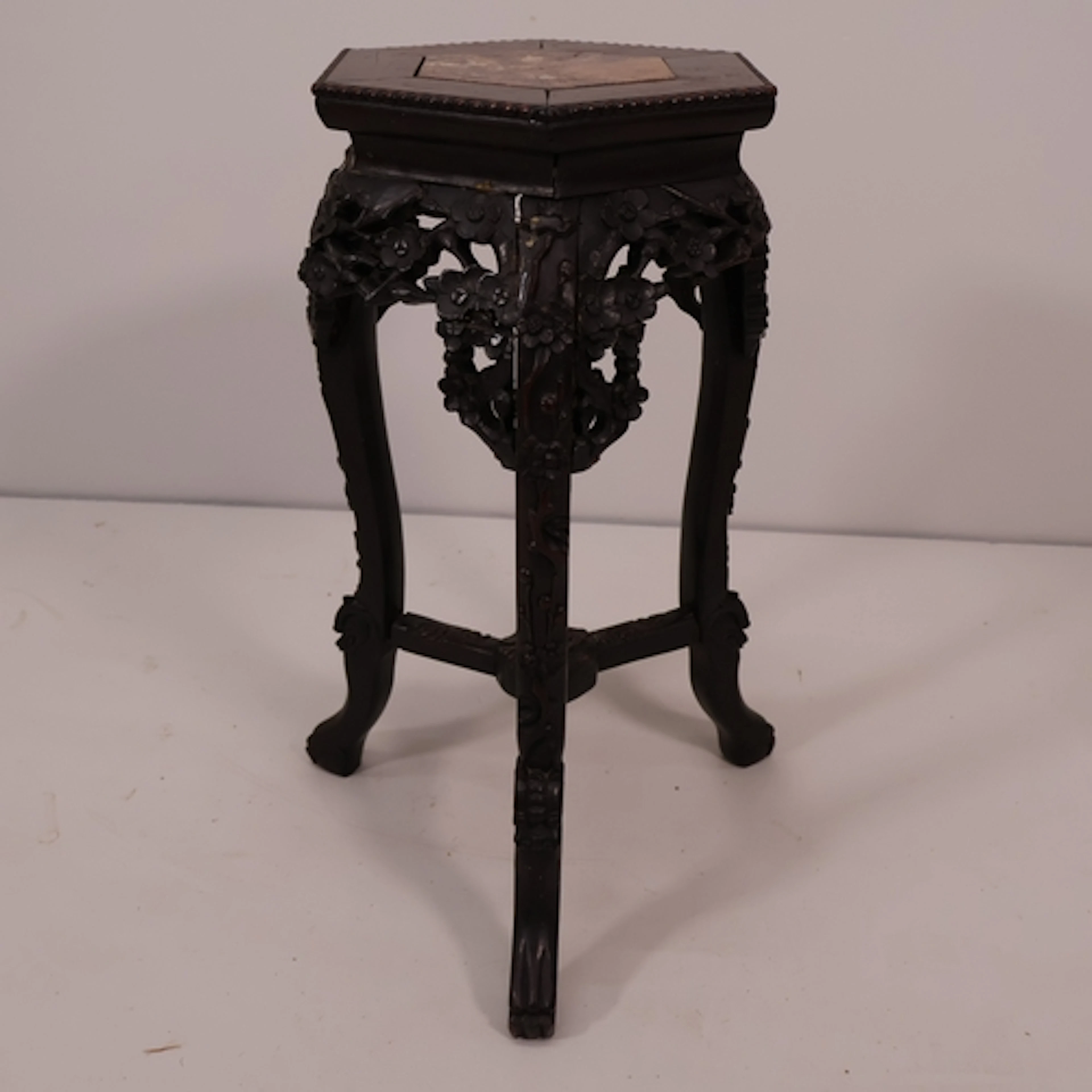 An antique Chinese hardwood hexagonal plant stand, with inse...