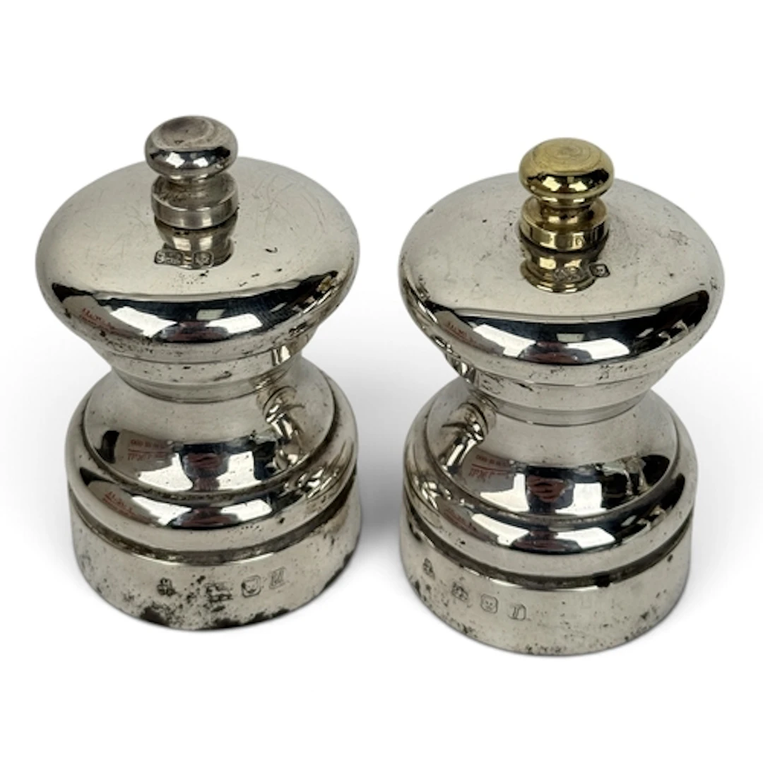 A PAIR OF ELIZABETH II SILVER PETER PIPER SALT AND PEPPER MI...