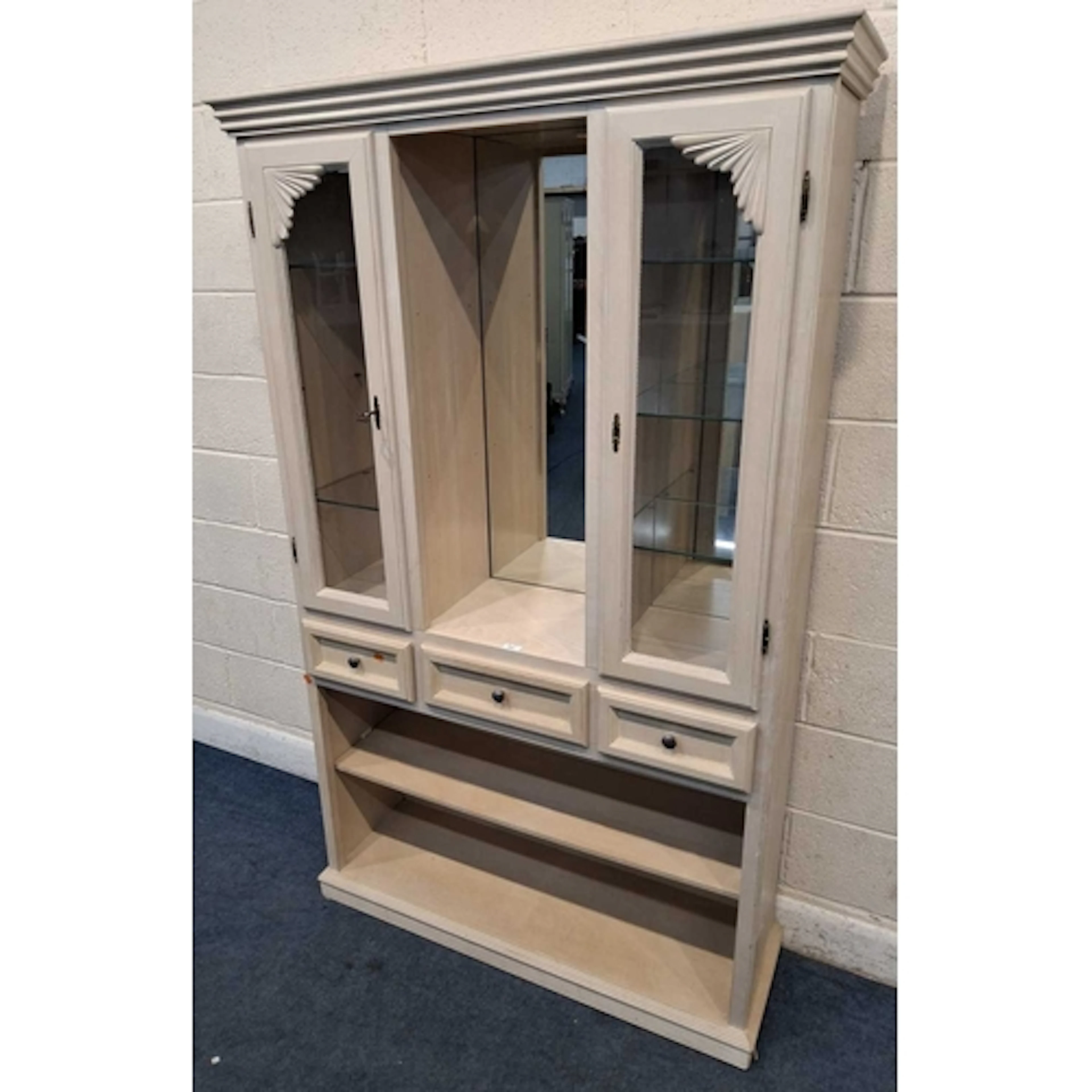 A MODERN DISPLAY CABINET, the two glass doors enclosing a mi...