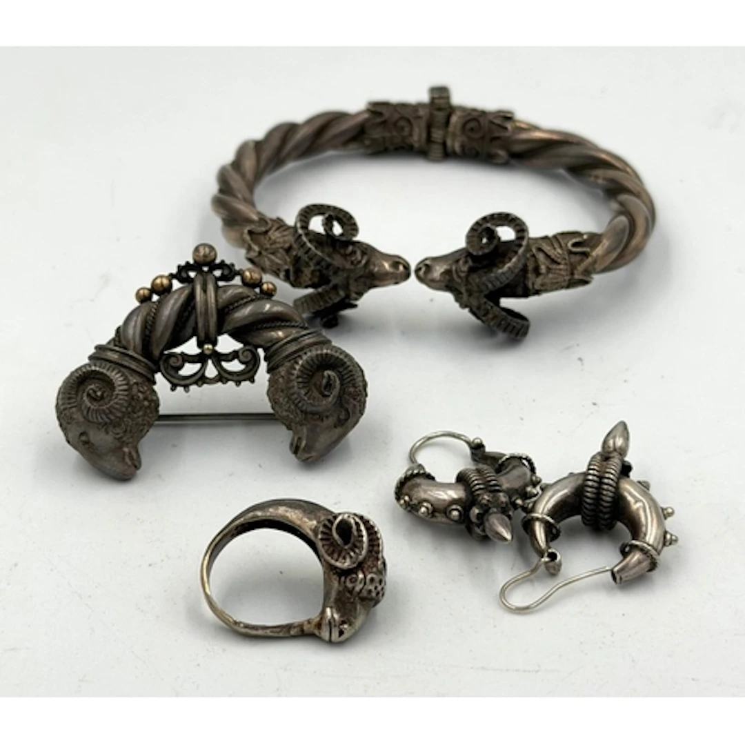 A suite of silver jewelry with a Ram's Head theme, including...