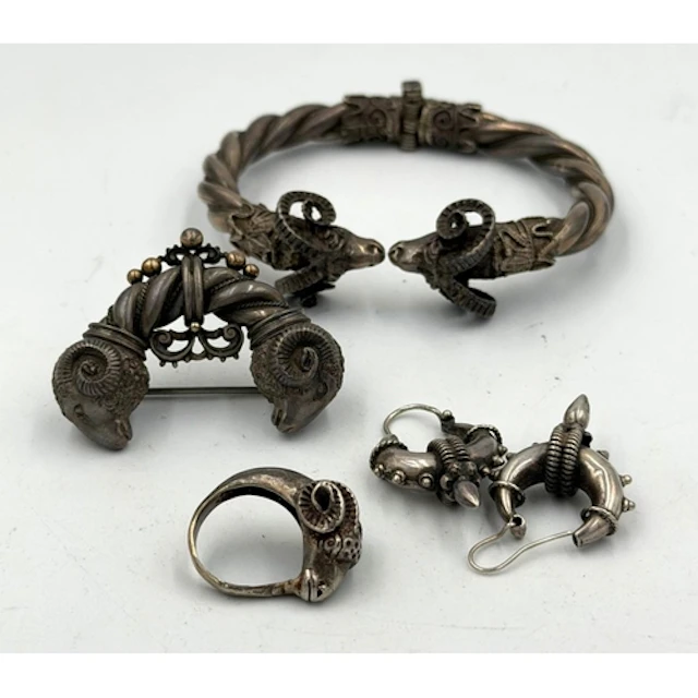 A suite of silver jewelry with a Ram's Head theme, including...