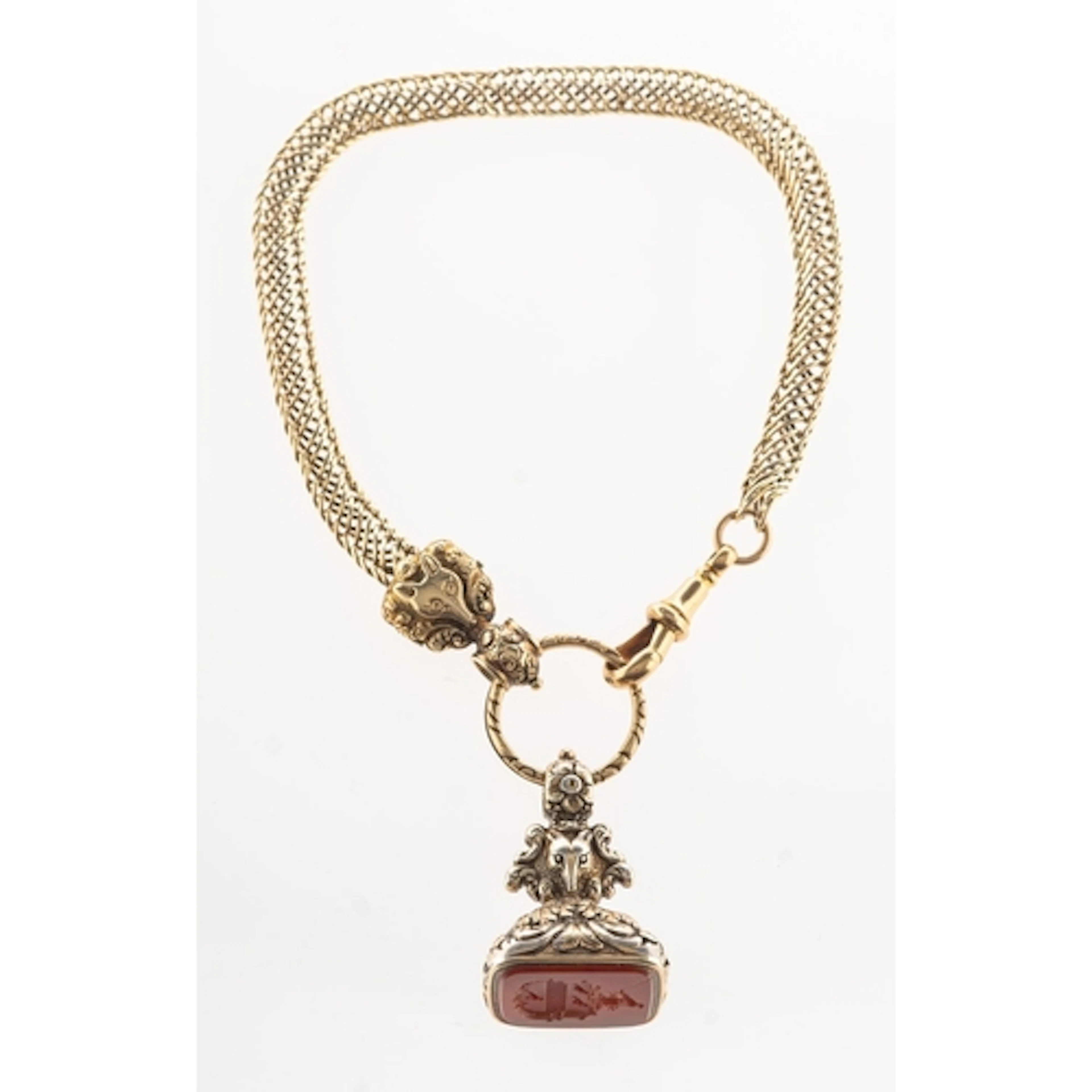 A Victorian watch chain and a carnelian fob seal, the watch ...