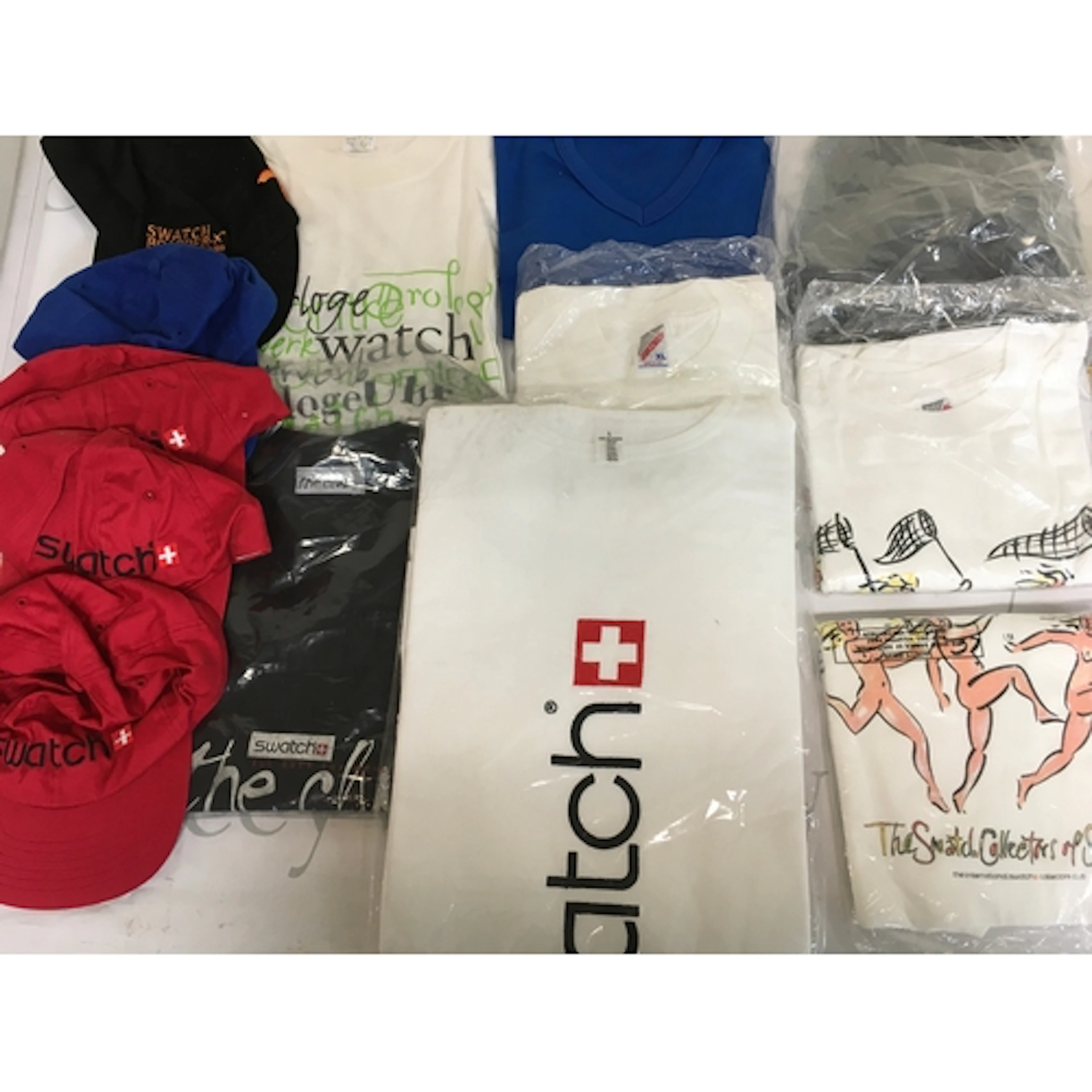 A collection of assorted swatch T-shirts and caps