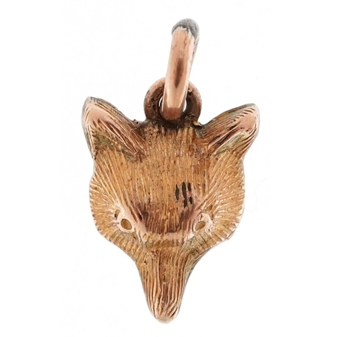 Unmarked gold charm in the form of a fox head, 10.0mm high, ...