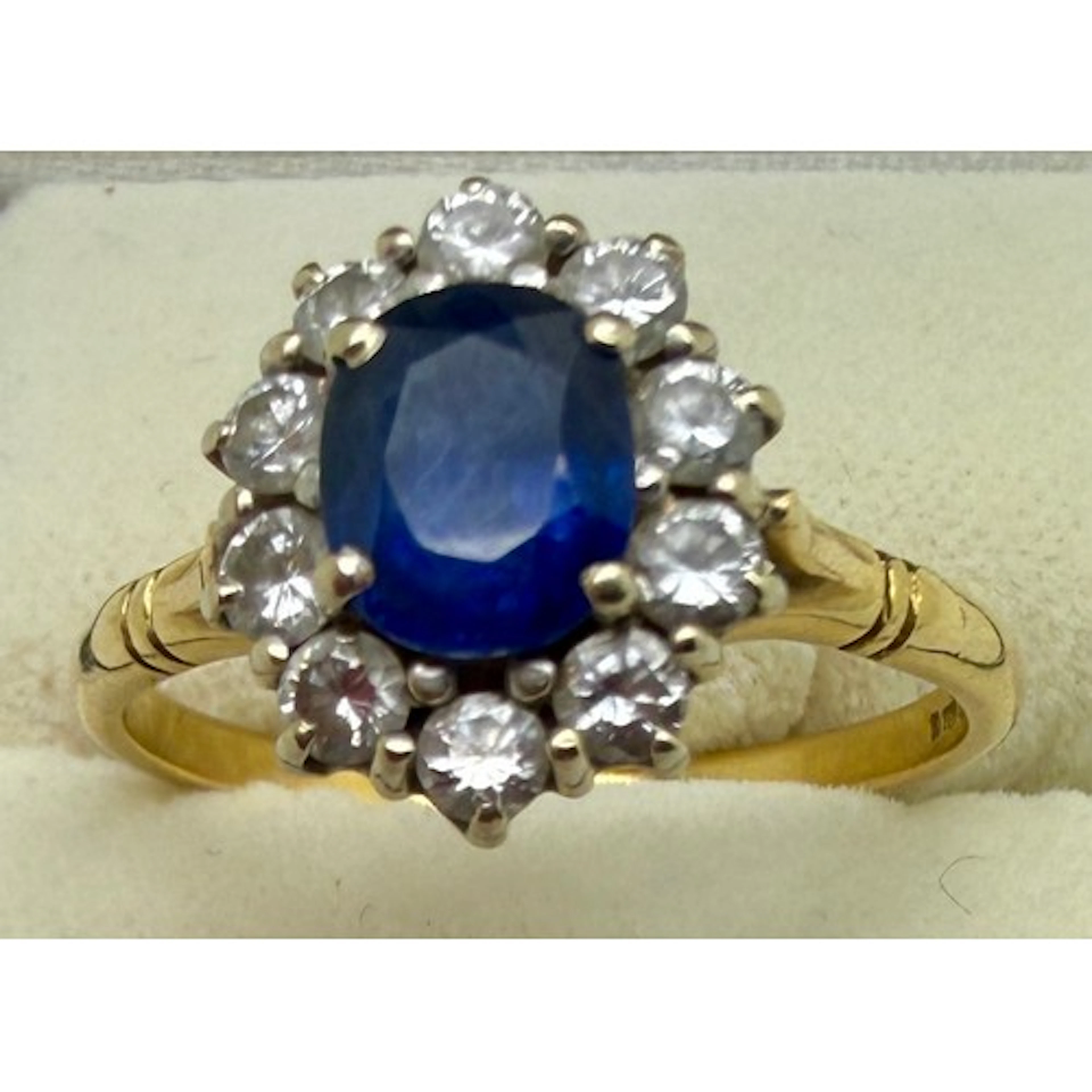 A sapphire and diamond cluster ring set in 18 carat yellow g...
