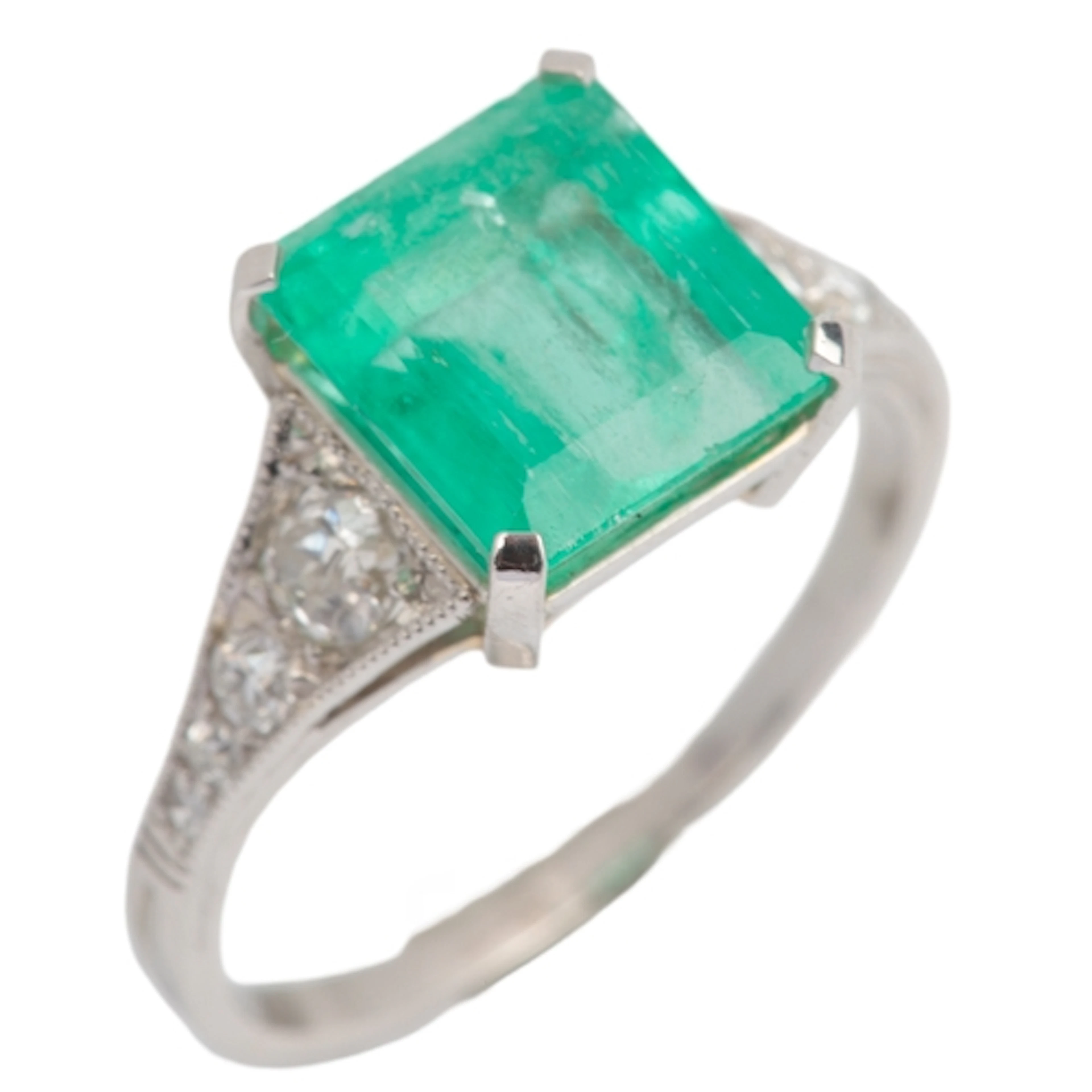 An emerald and diamond ring, early 20th century, claw-set wi...