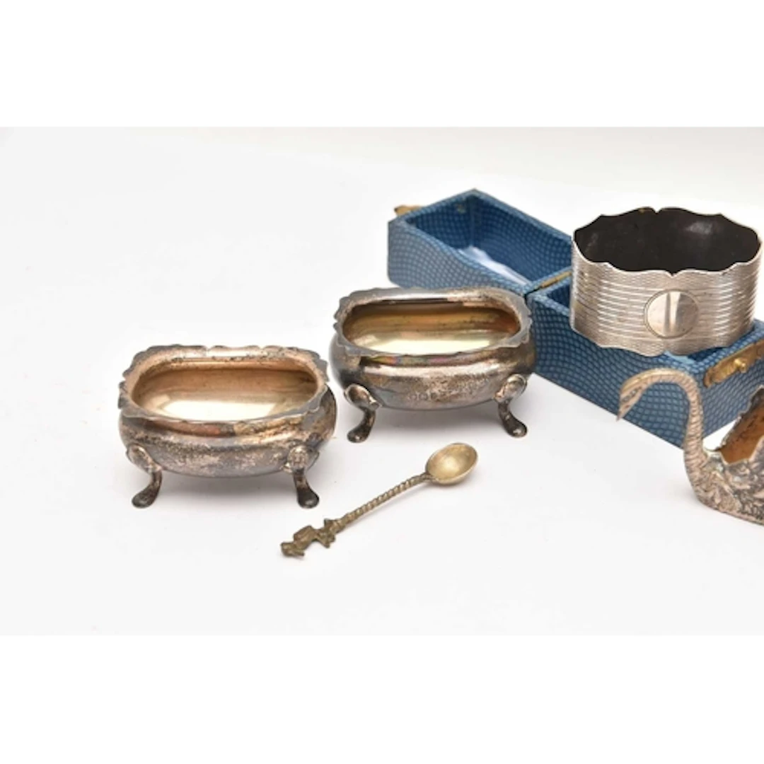 AN ASSORTMENT OF SILVERWARE, to include three napkin rings o...